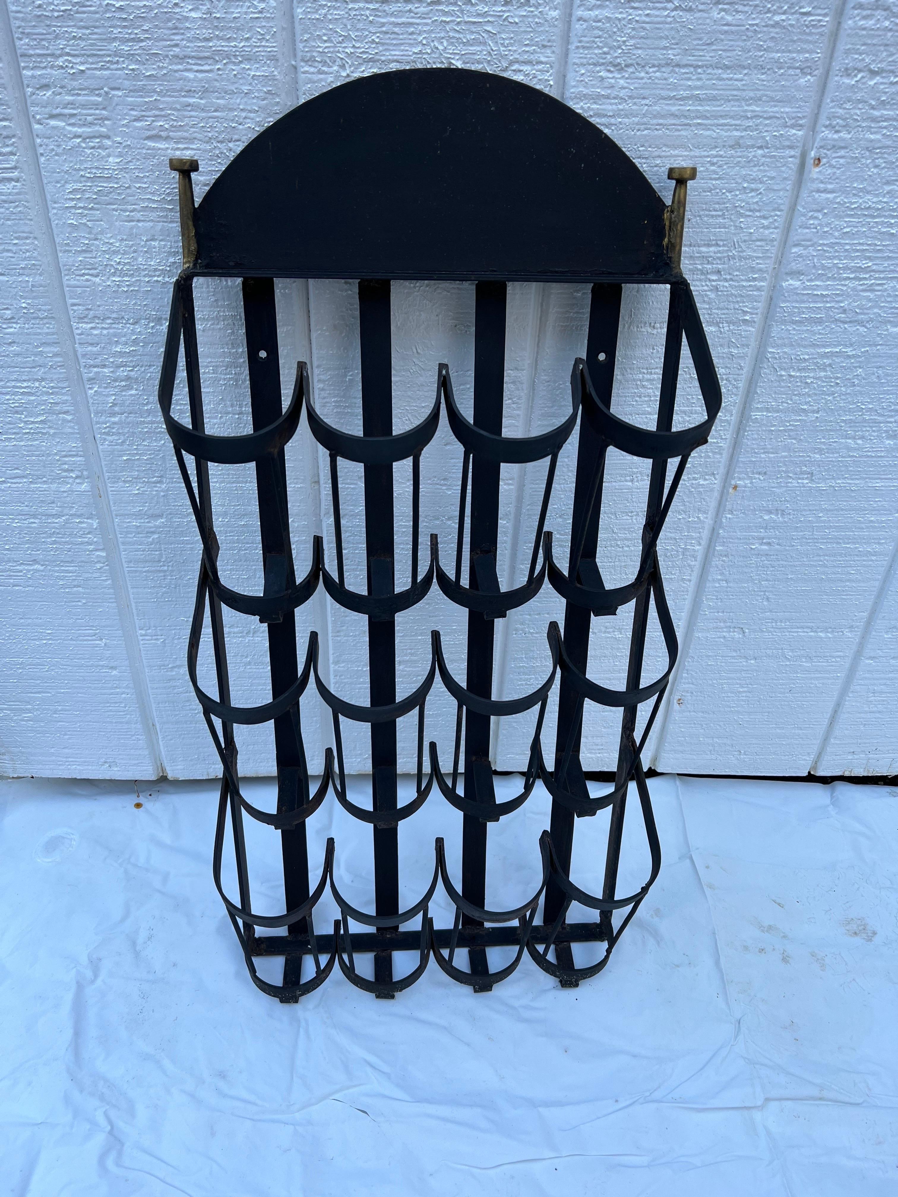 Wrought Iron wall mount wine bottle holder. Holds 12 bottles total. Perfect for that rustic barn home or modern penthouse. Great unique gift for that sommelier , home made wine maker , or just wine lover in general. There are two holes for screws to