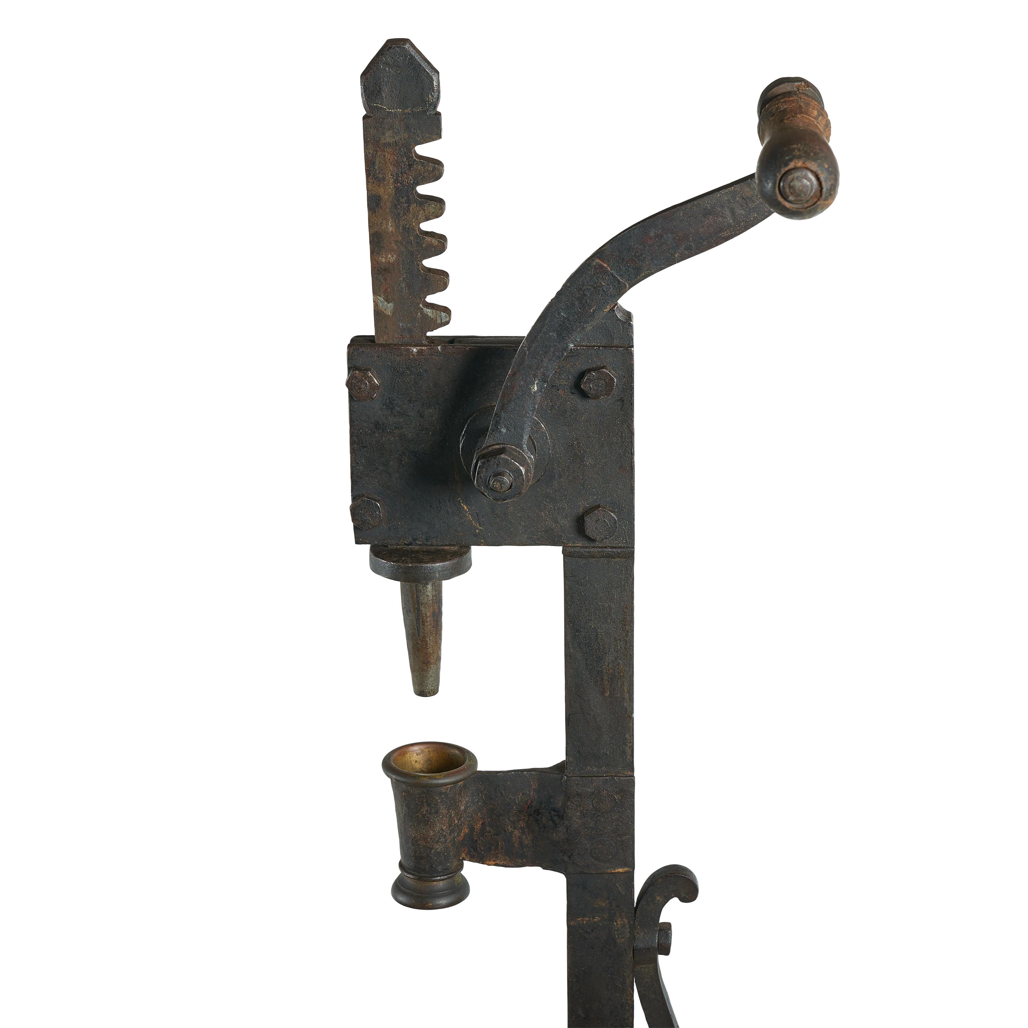 Wrought Iron floor mounted cork press with wood base for wine bottles.