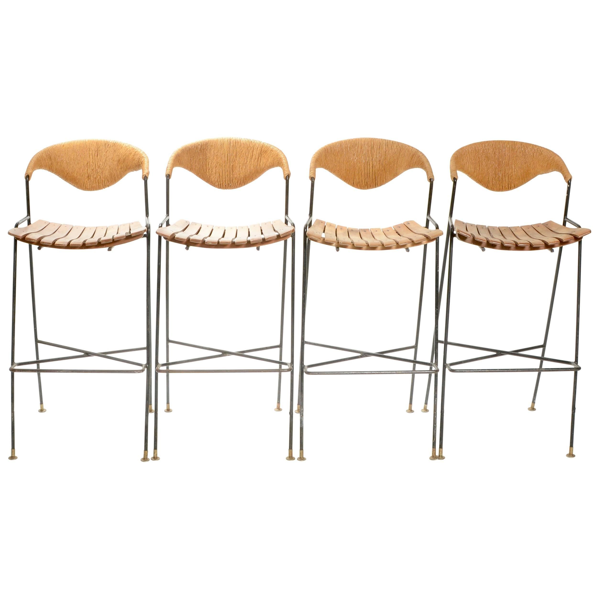 This is a great set of Arthur Umanoff bar stools made from wrought iron and paper cord. We have 2 left in stock. Price is per chair.