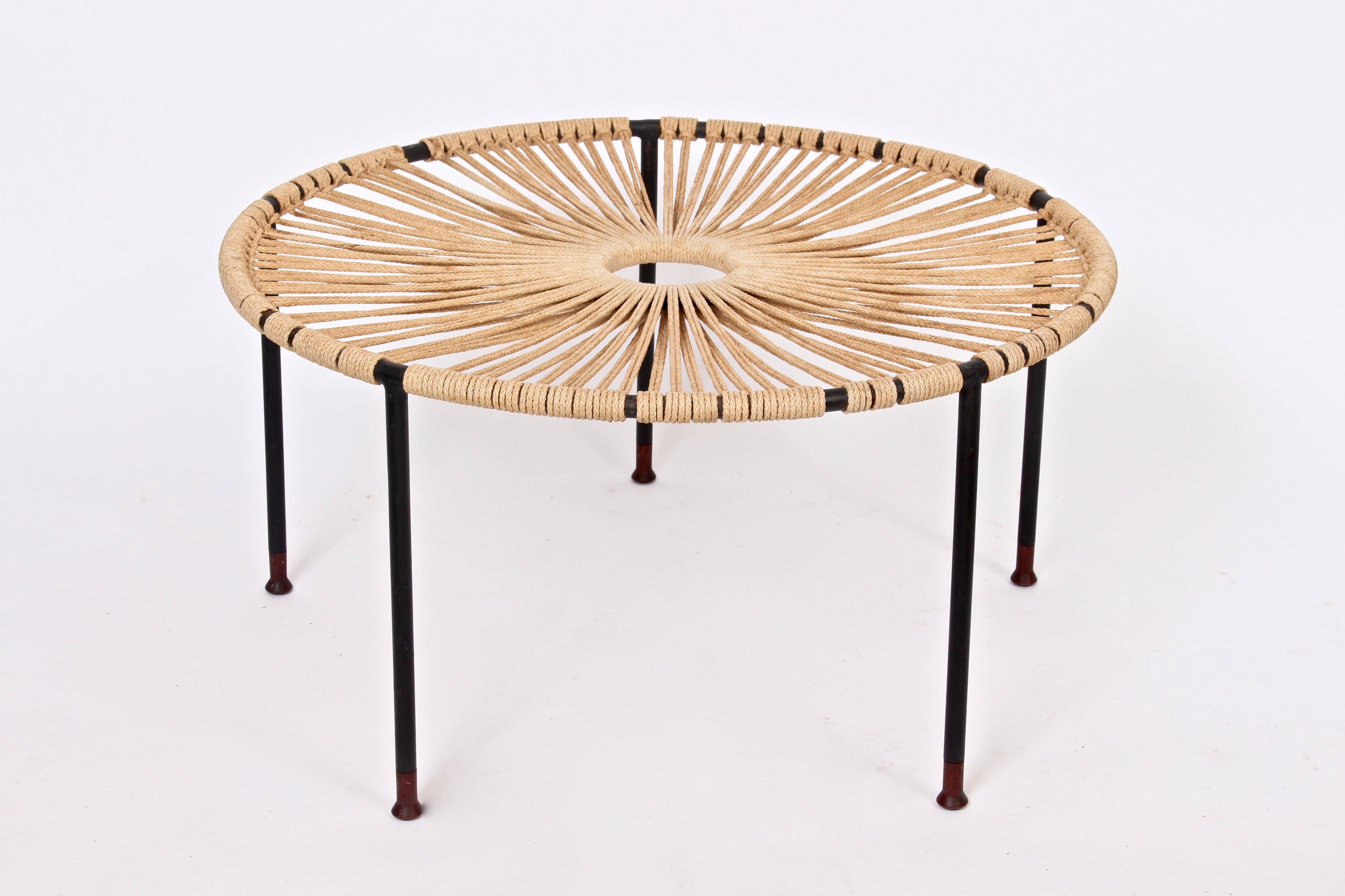 Mid-20th Century Occasional Table, Catch All in black wrought Iron, hemp rope and teak. Featuring a tubular black wrought iron five legged frame wrapped with a sunburst design in taut, textured woven Hemp rope and detailed with hand turned teak