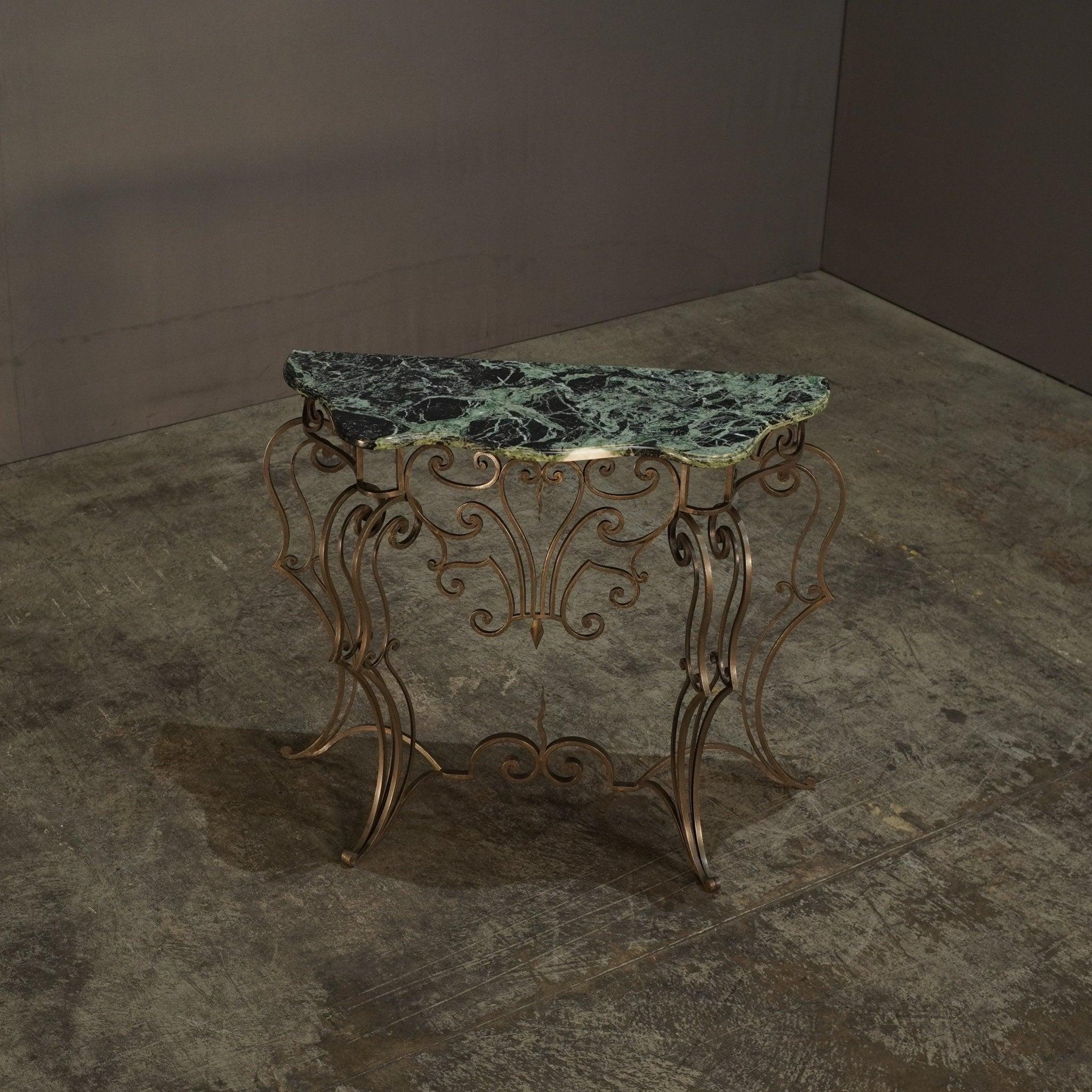 The Wrought Iron & Marble Console is a striking piece of furniture. Its combination of sturdy wrought iron and elegant marble creates a sophisticated and timeless look, perfect for any entryway or living room. 

*Please Note that items shown