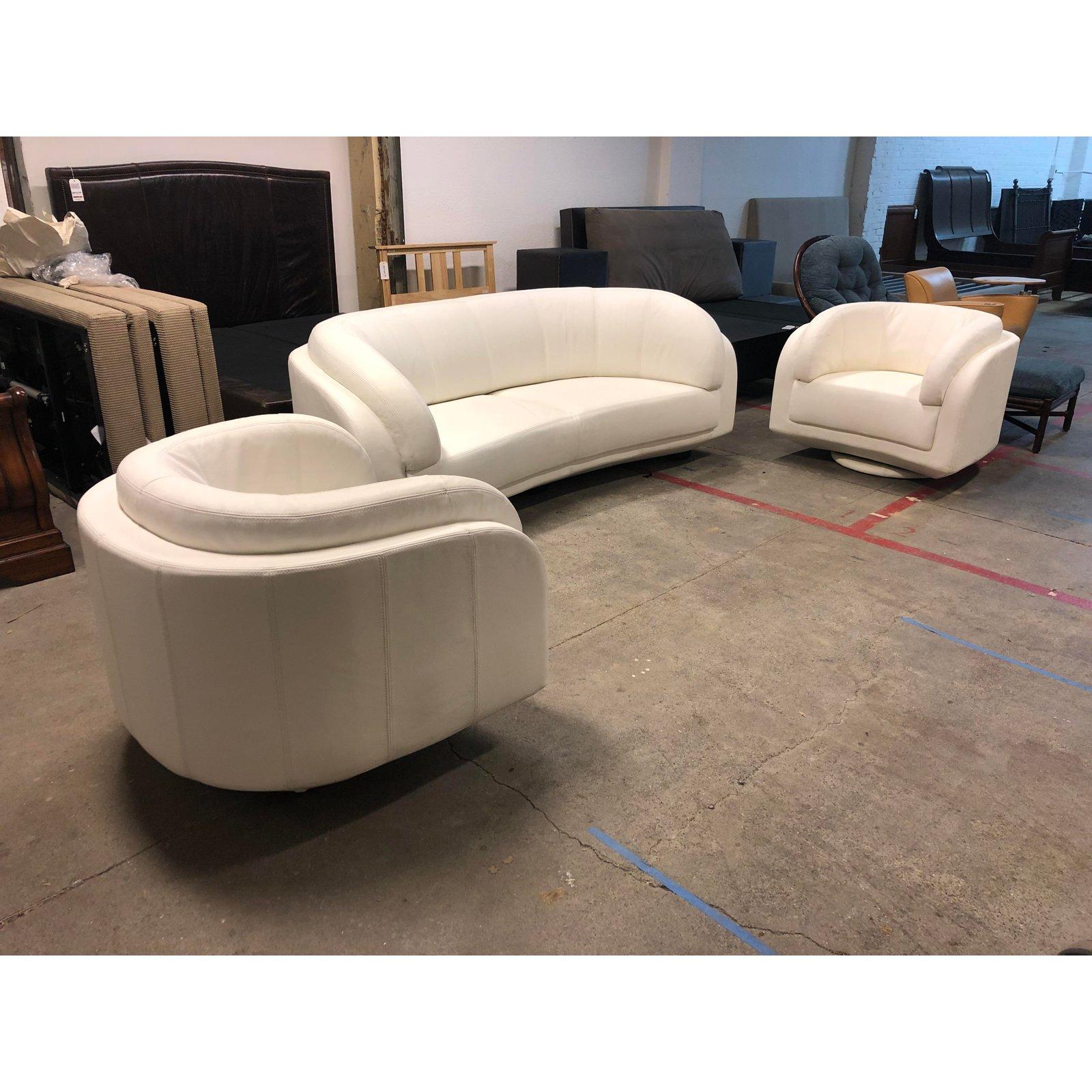 An Arabesque sofa and pair of swivel chairs by W.Schillig, The Arabesque Collection was designed by Fillmore Harty. A curvaceous sofa that envelopes in comfort and surrounds the seater in style. A unique cantilever base creates a light, floating