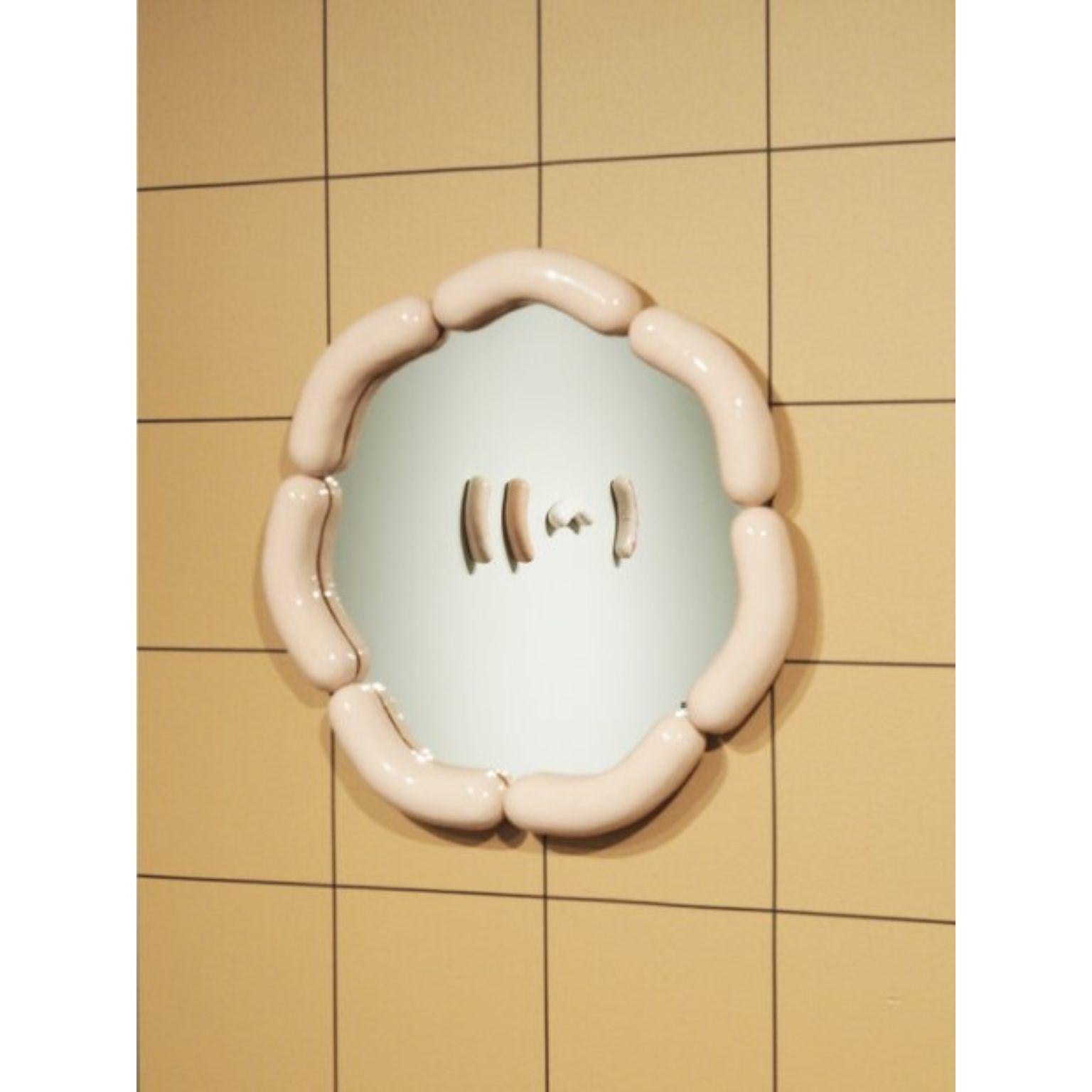 Wurstie mirror by Tero Kuitunen
Material: hand built ceramic, glass mirror, wood
Dimensions: D 49 x W 49 x H 5 cm
Numbered and signed.

Ceramic wall mirror, numbered. Open edition.

Designer Tero Kuitunen, b. 1986, is inspired by the