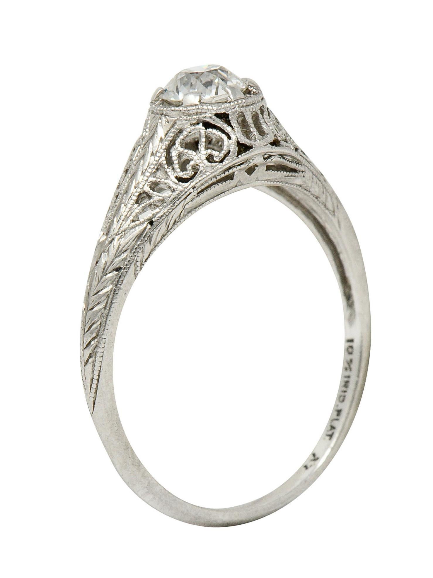 Centering a transitional cut diamond weighing approximately 0.35 carat; J color with VS clarity

Set low in mounting with a pierced filigree gallery and foliate engraved shoulders

Stamped for platinum

Numbered and with maker's mark for W.W. Fulmer
