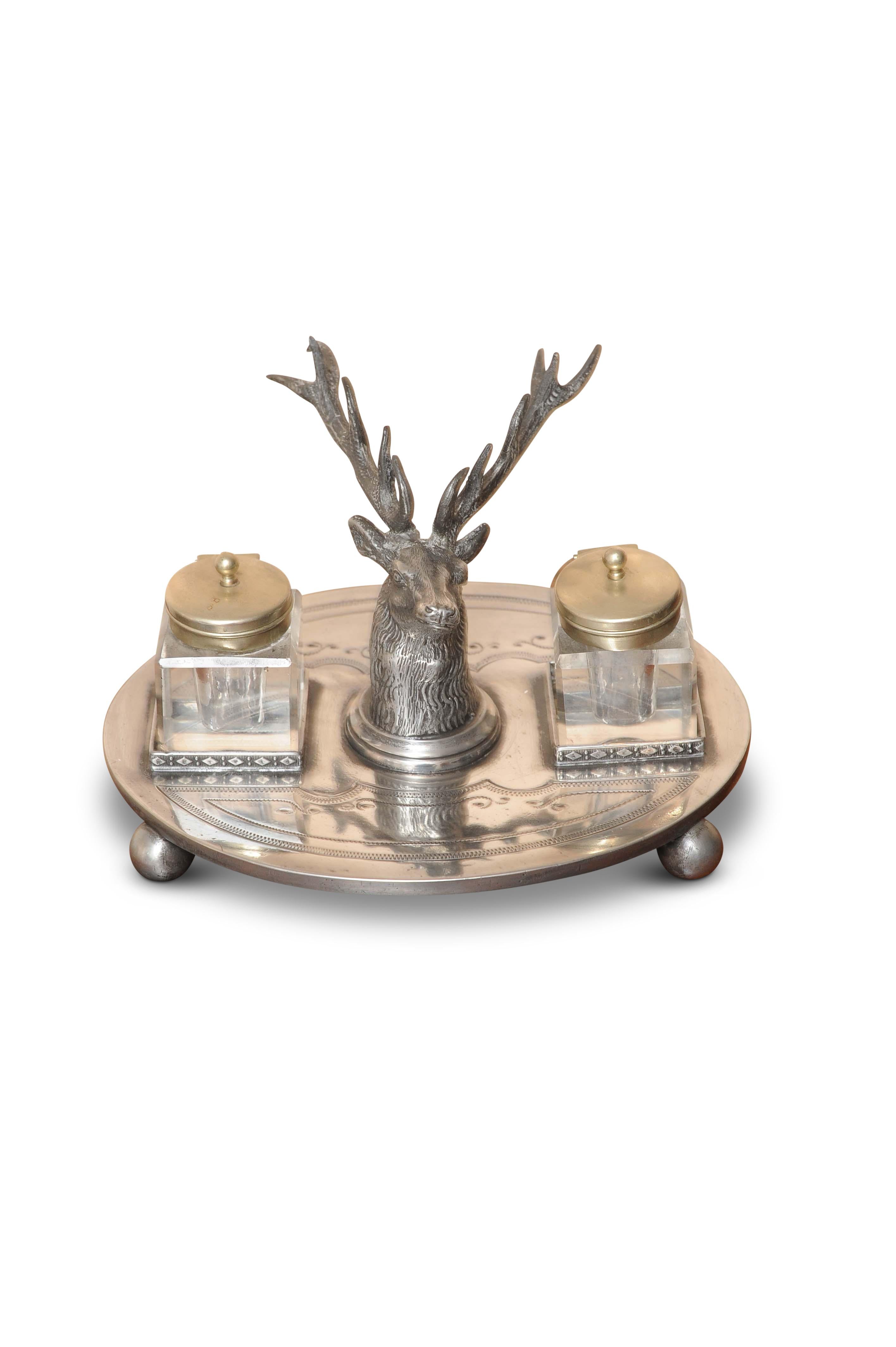 WW Harrison & Co Ep Victorian desktop ink stand Art Nouveau style.
The Stags' head is the centre piece, flanked by two cut glass ink pots, finished off on a silver EP stand on bun feet.   
   