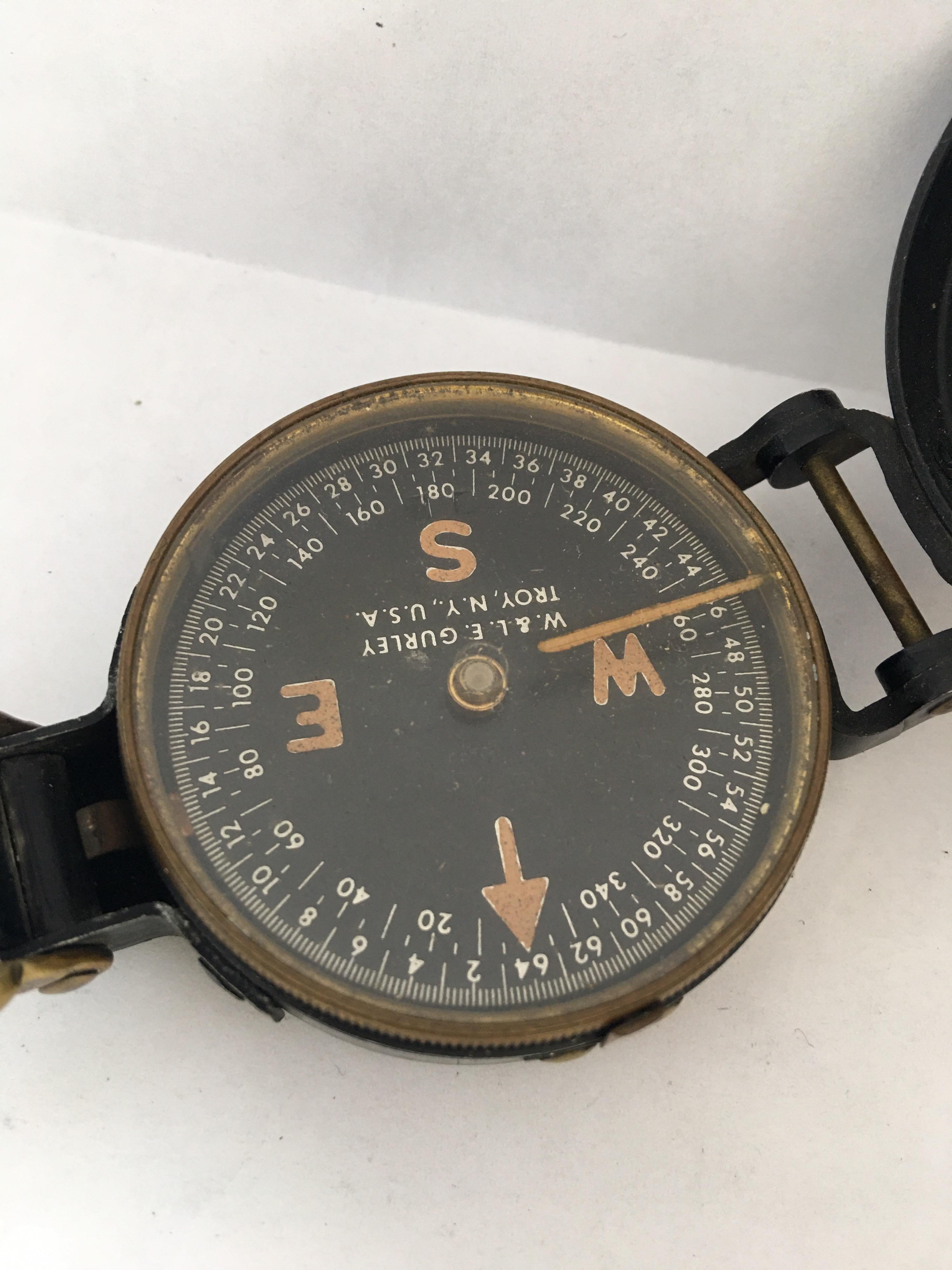 WW II Field Compass manufactured by W & L..E. Gurley Company in Troy, NY. Compass body is made of aluminum and painted black with thumb ring, a magnetic floating dial, rear sight with magnifying lense and sighting wire intact. aluminbody measures