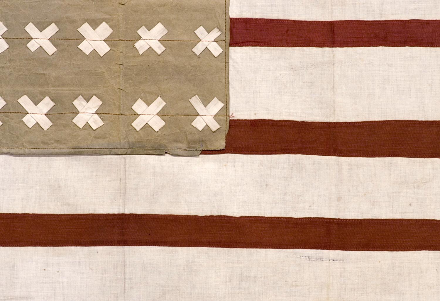 WWI, BELGIAN-MADE VERSION OF THE STARS & STRIPES WITH 30 CROSS-HATCH STARS, USED TO WELCOME U.S. SOLDIERS INTO THE CITY OF VIRTON, BELGIUM IN 1918, FOLLOWING ITS LIBERATION FROM GERMAN OCCUPATION

This 30 star flag was homemade by a Belgian citizen