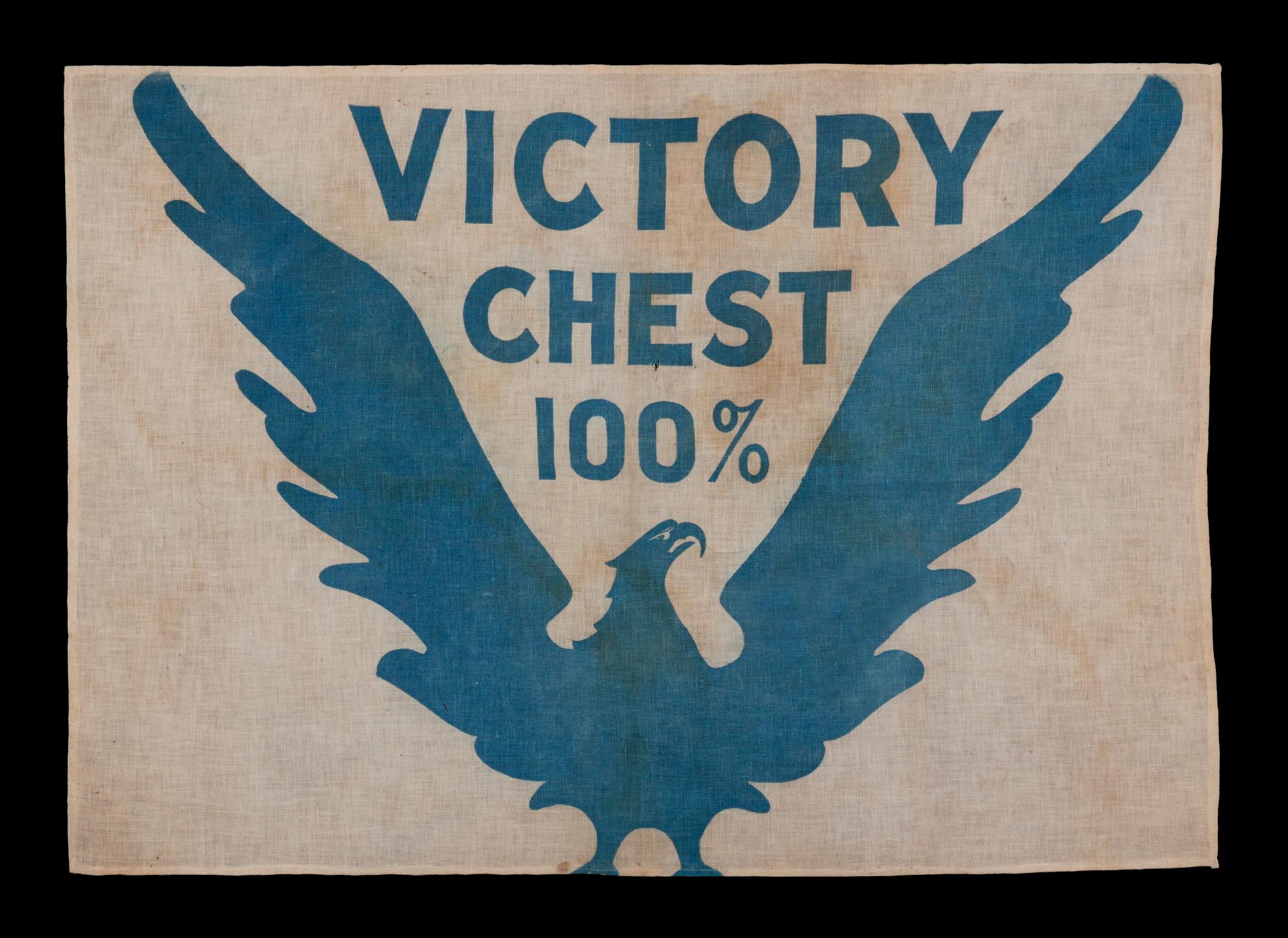 WWI BOND DRIVE FLAG WITH A WHIMSICAL & ARTISTICALLY COMPELLING EAGLE, PERCHED DIRECTLY ON THE LOWER EDGE OF THE TEXTILE (HIGHLY UNUSUAL), WITH WINGS UPSTRETCHED IN A “V” FOR “VICTORY” TO CRADLE THE WORDS “VICTORY CHEST 100%;” PRUSSIAN BLUE ON A
