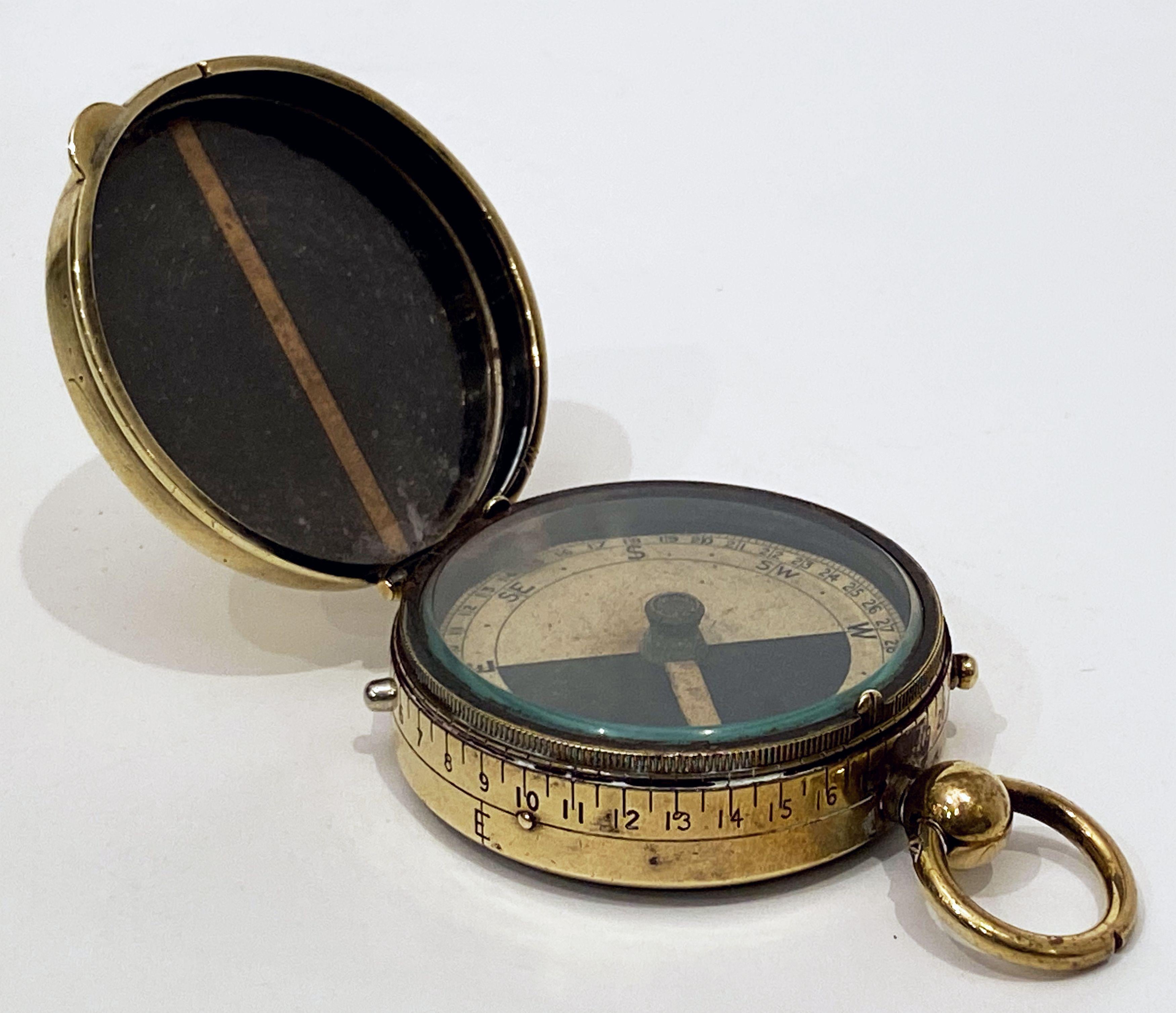 A working military officer's marching or sighting compass of heavy brass from World War One, an excellent original example of the Cbynite Radium Compass.
Featuring a brass case and mounted with a lanyard ring.
The glass faces and numbered brass