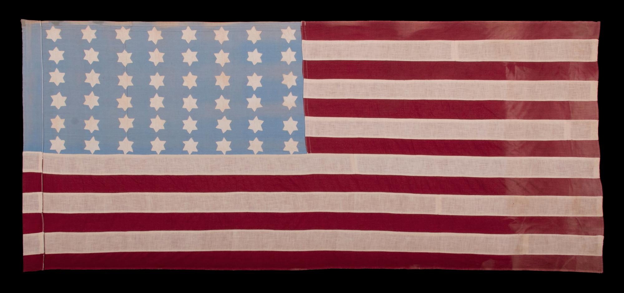 WWII American Flag With An Elongated Profile, A Sky Blue Canton, And 48 Six-pointed Stars With Star-of-david Profiles; Probably Made In France Or Belgium To Welcome U.s. Troops Following Liberation From The Germans, circa 1944, An Exceptional