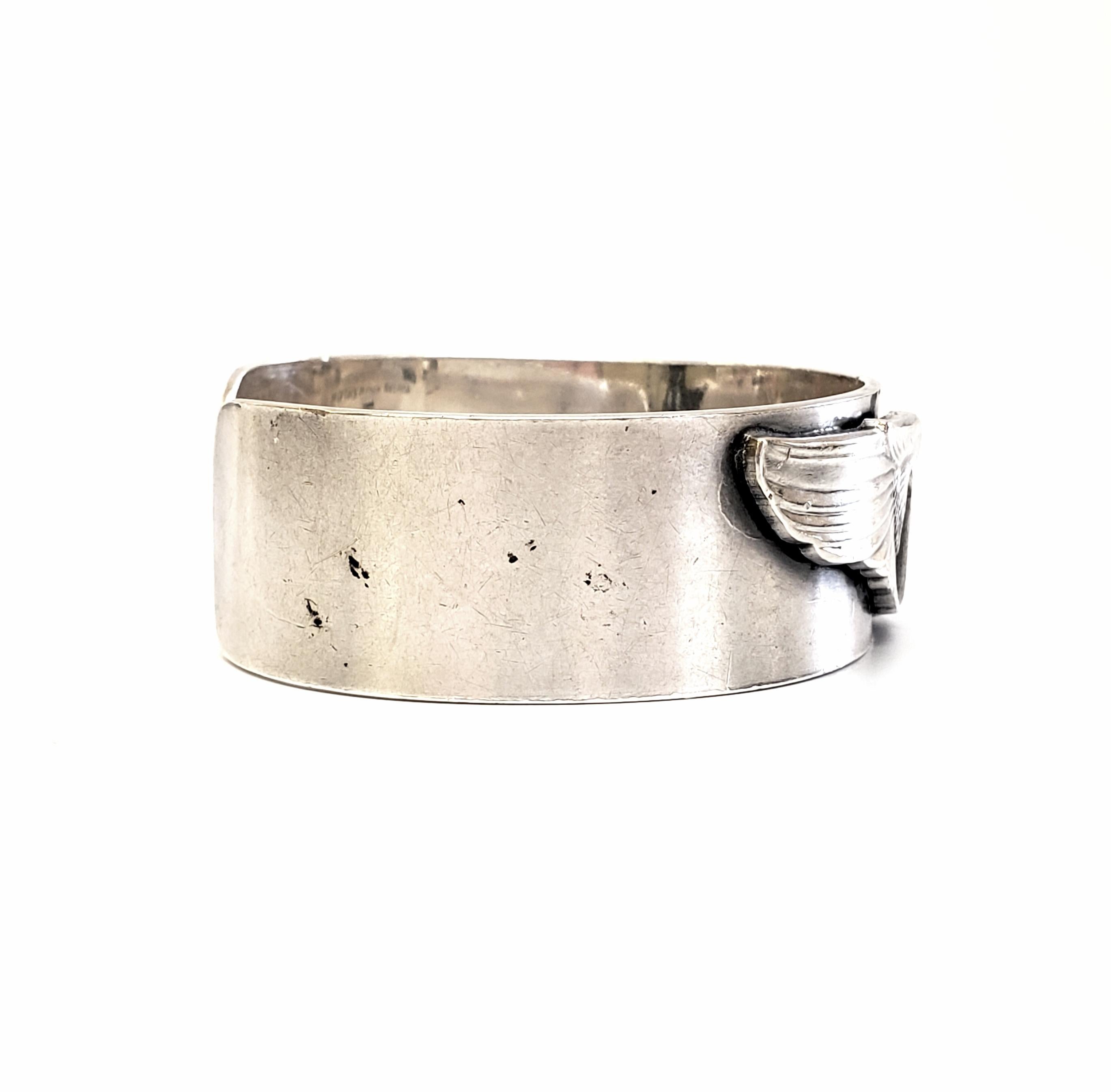 Sterling silver cuff bracelet featuring Air Force Airman's wings and shield.

Engraved on the inside, 