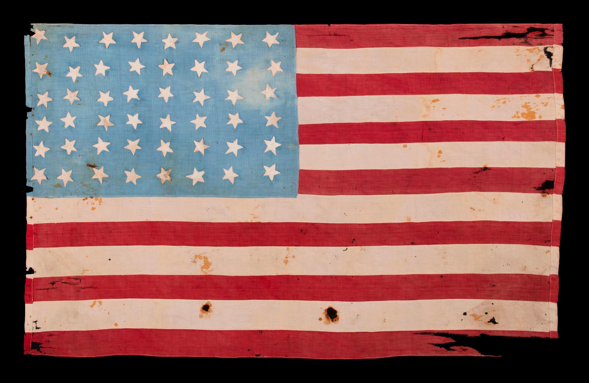 WWII Liberation Flag with 48 Hastily Sewn Stars on a Beautiful, Cornflower Blue Canton, Found Behind a Cabinet in a Paris Basement, Made to Welcome U.S. Troops in France Following Liberation from The Germans In 1944, a Wonderful Example with