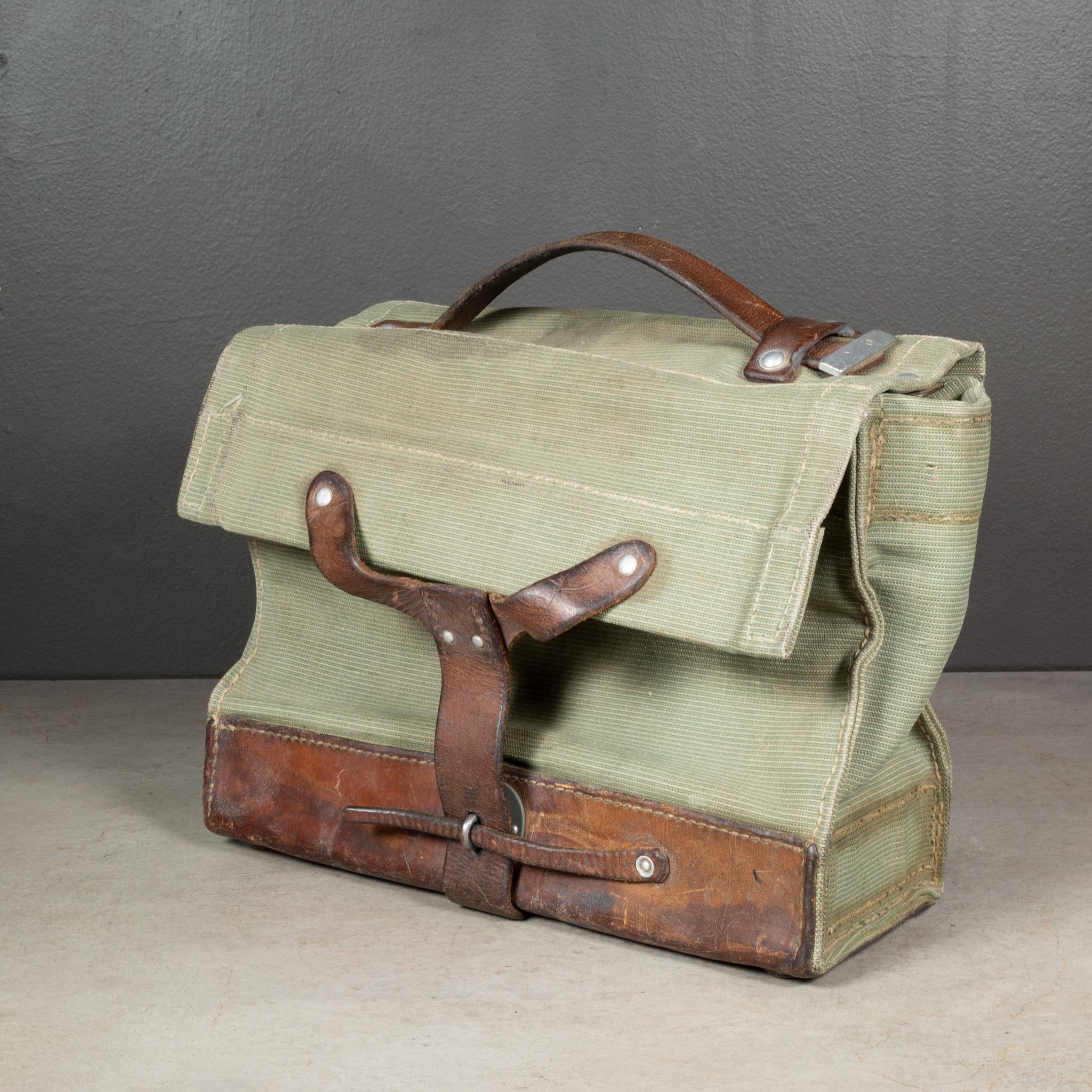 ABOUT

A vintage Swiss Army canvas and leather carrying case with silver rivets and brass feet. The interior inside top is lined with leather. Unique leather strap close. Swiss cross stamped on the front leather strap.

    CREATOR Unknown. Swiss