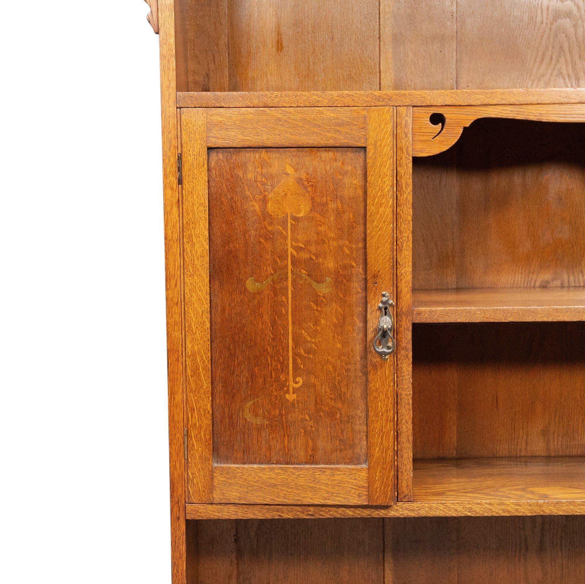 Oak Wylie and Lochhead, in the style of. Arts and Crafts oak bookcase with cupboard For Sale