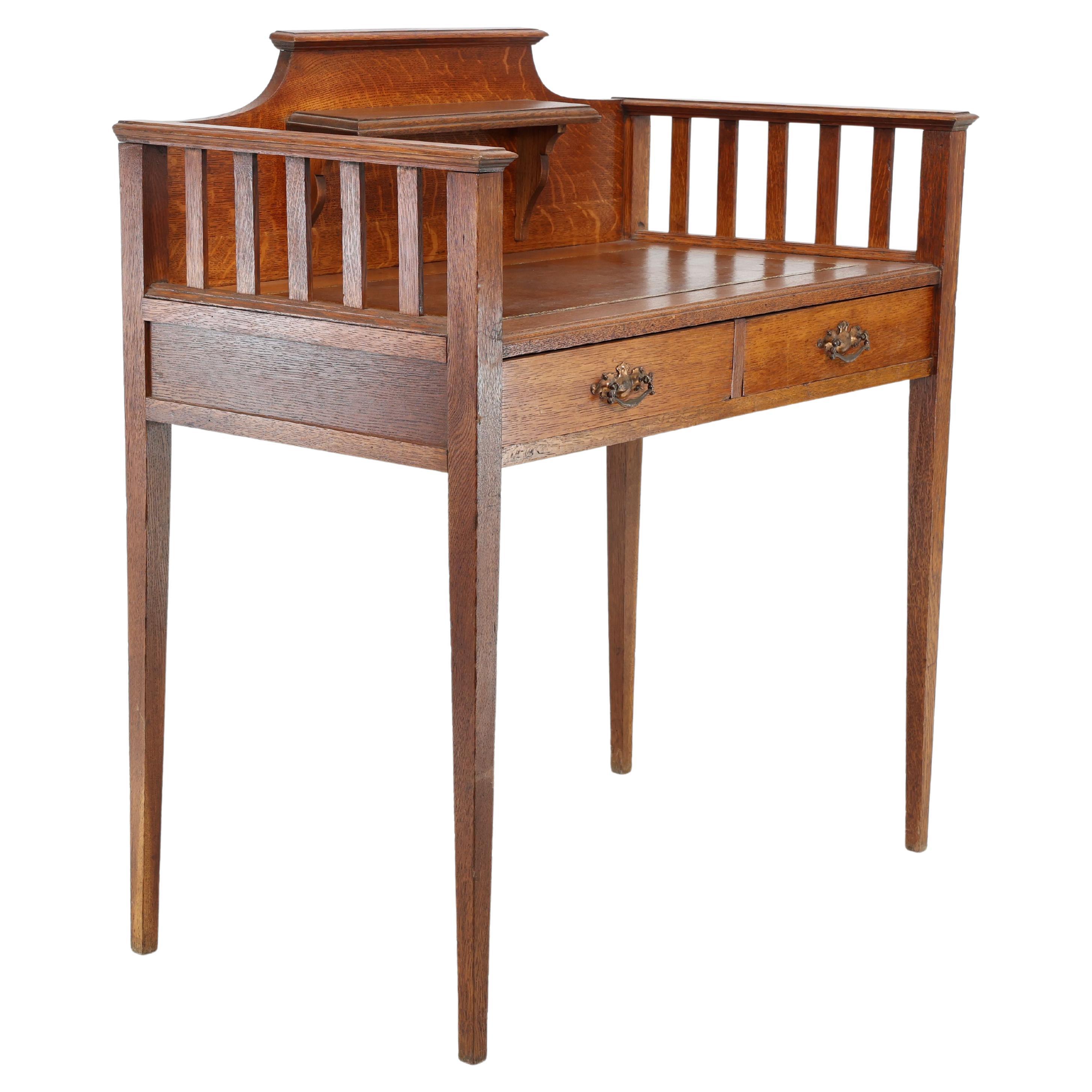 Wylie & Lochhead attri. An Arts & Crafts oak desk with new leather writing area