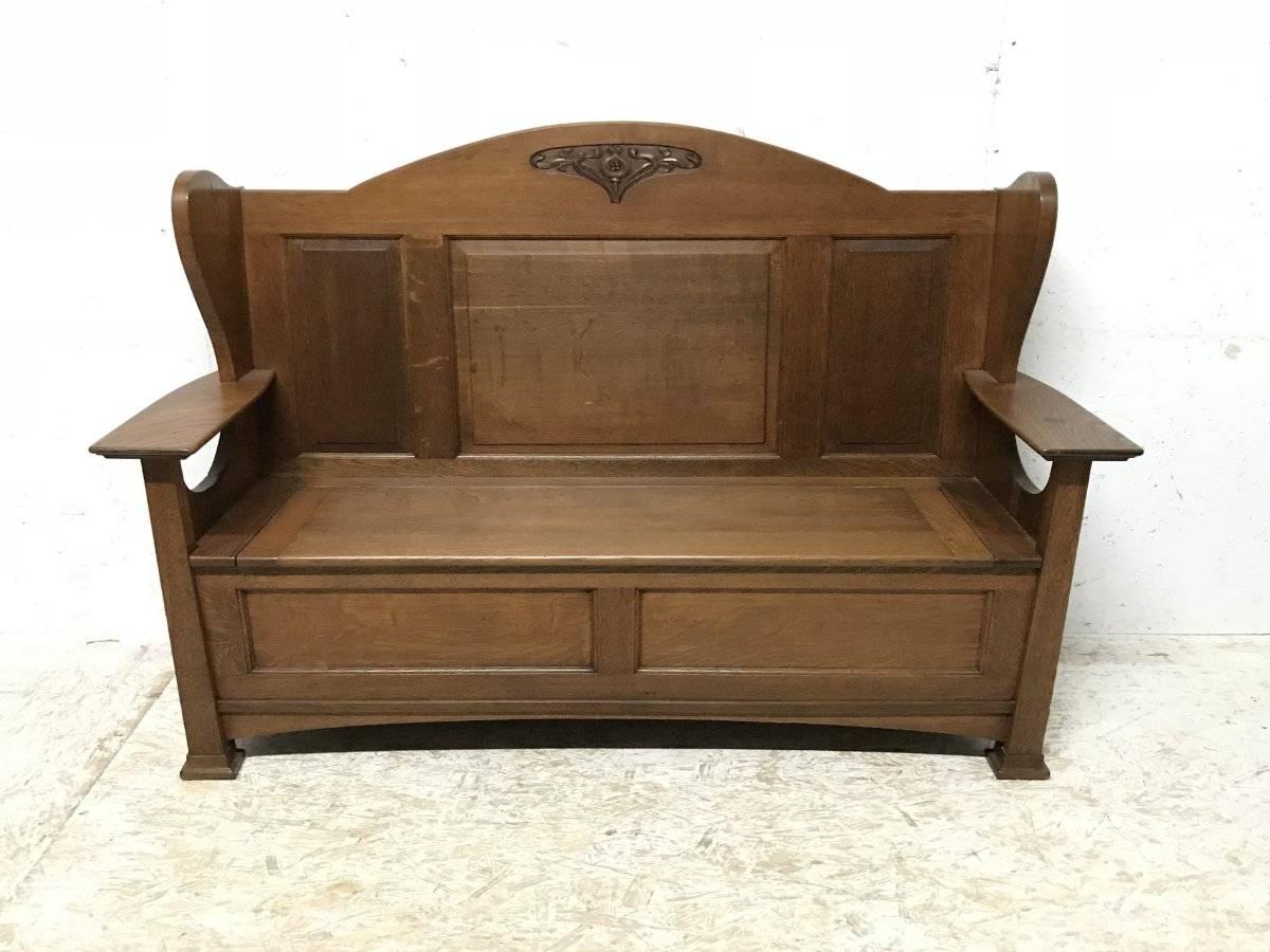 Wylie and Lochhead maker, after a design by M H Baillie Scott.
A good Arts & Crafts Glasgow School oak wing back settle, with stylized floral carved detail to the top and sweeping side details and a generous storage compartment below the lift up