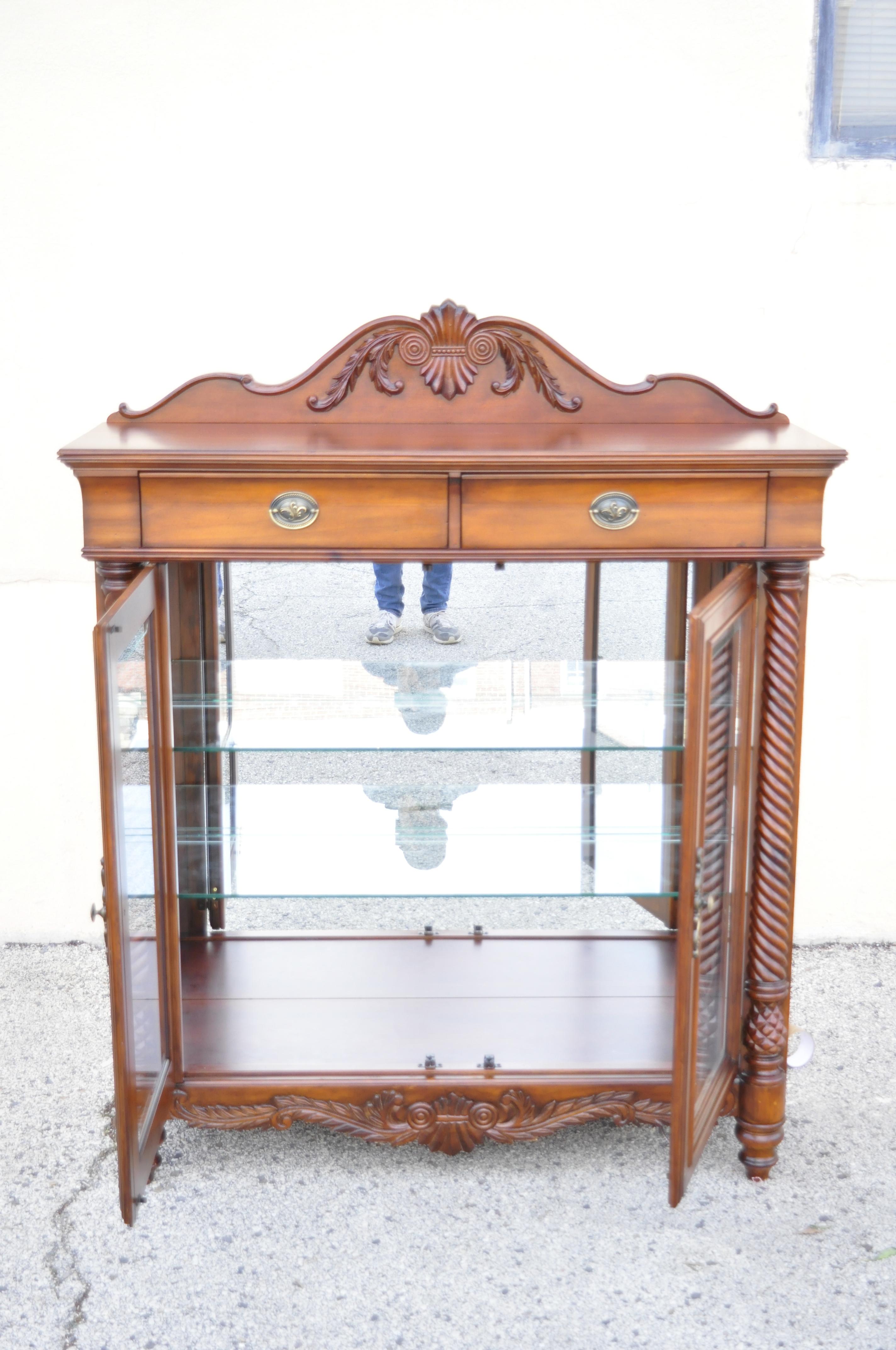 Wynwood Flex steel empire carved cherry wood glass display curio china cabinet. Item features carved wood backsplash, spiral carved columns, beautiful wood grain, nicely carved details, lighted interior, original label, 2 drawers, 2 adjustable glass
