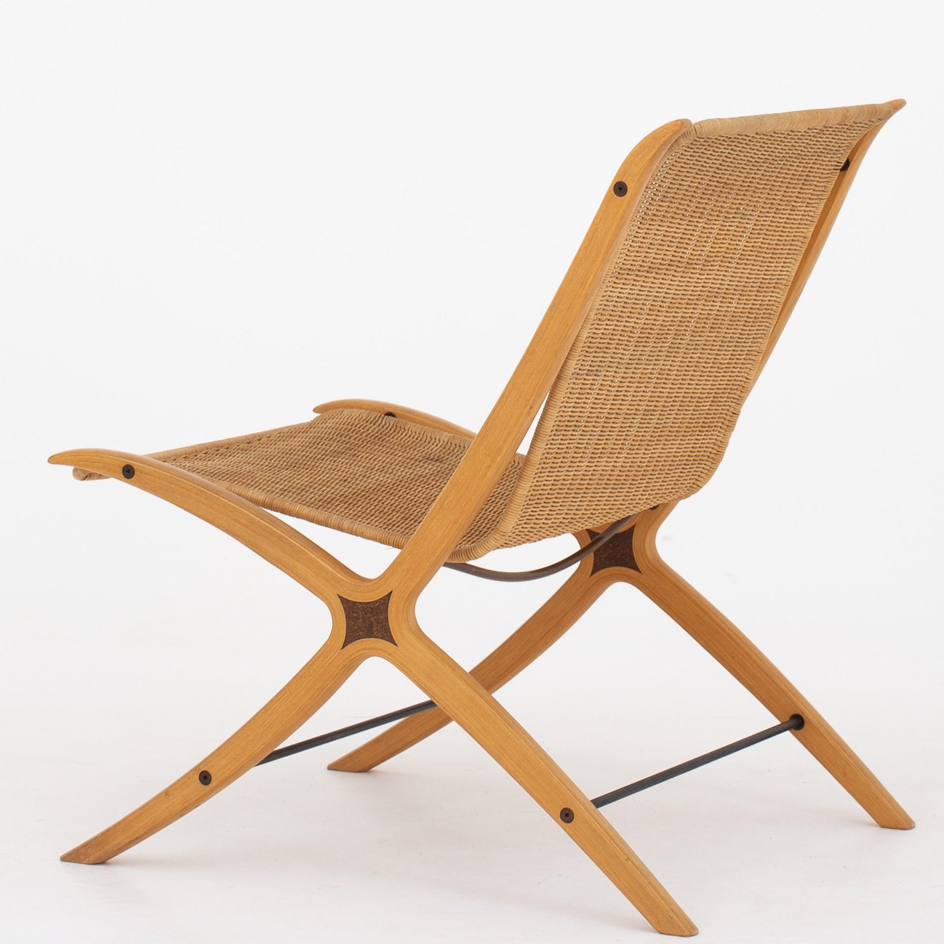 The 'X-chair' in form-bent, laminated beech wood with inlays and original cane. Brass cross bars. Model 6103. Maker Fritz Hansen.