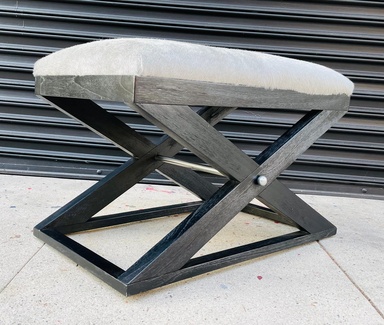 Beautiful X frame bench, the dark wooden frame has a black limed oak finish and stainless steel stretcher.
The bench is upholstered in a grayish cowhide upholstery.

Measurements:
30 inches wide x 18 inches deep x 20 inches seat height.

    