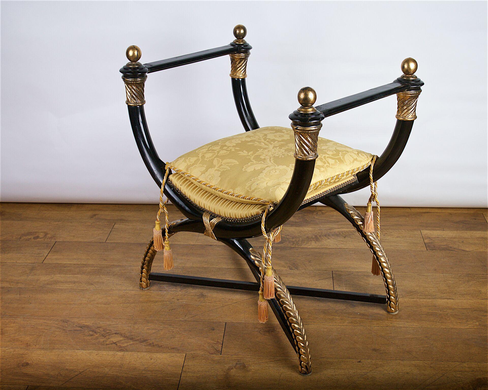 Mid-20th century X-frame stool in the Egyptian manner; ebonized and giltwood.