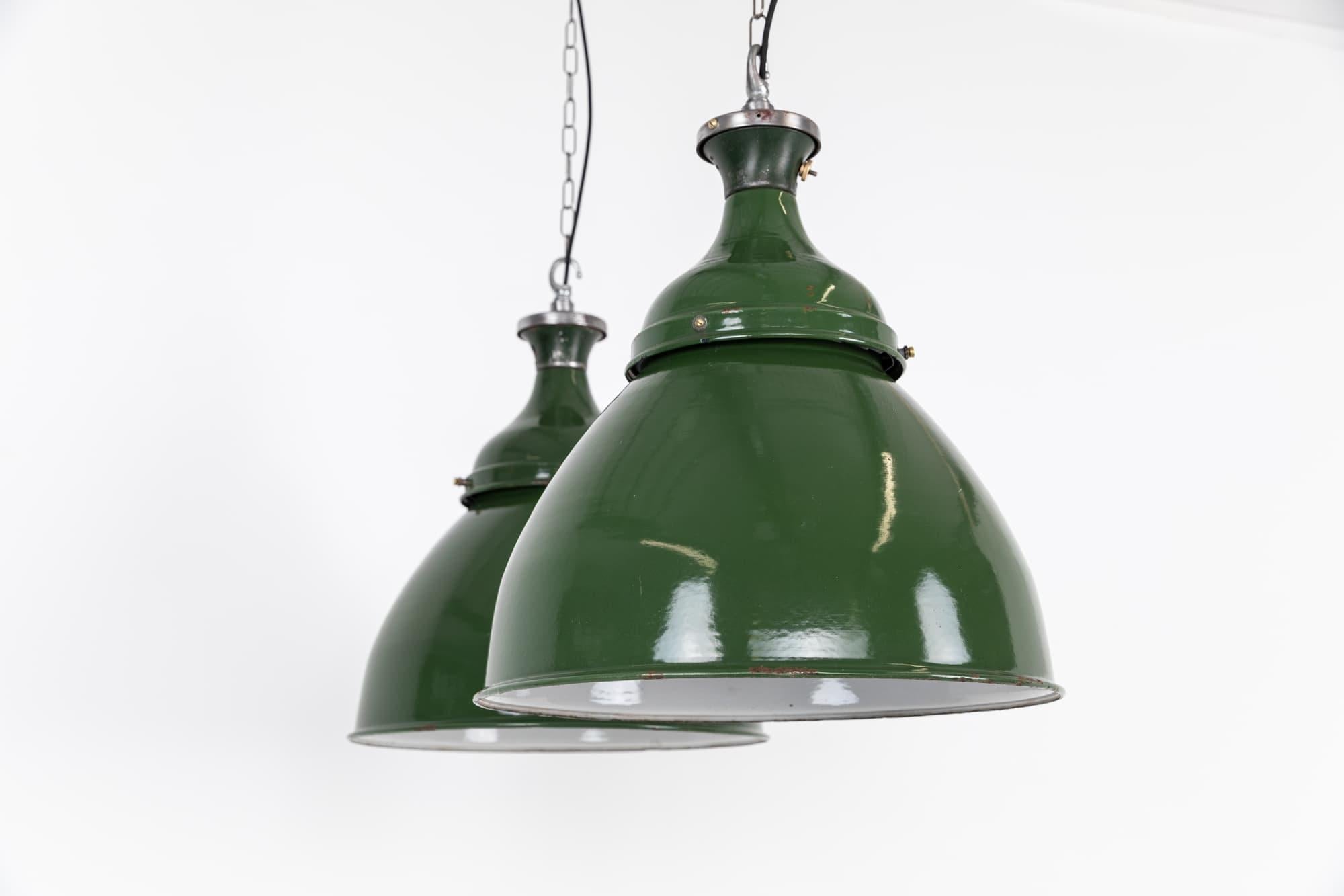 Huge green vitreous enamel pendant lights by renowned industrial manufactures Benjamin Electric. c.1940

In amazing original condition, with very little wear to the enamel. Price is per lamp.

Rewired with 1m of black round flex.
