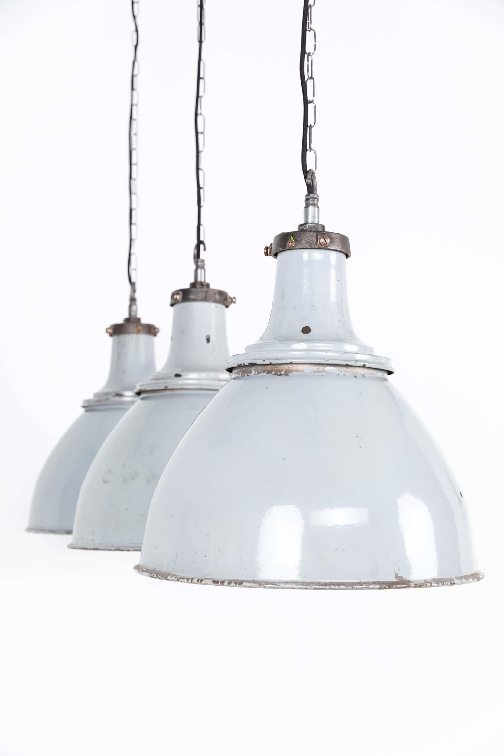 

A run of large grey enamel pendant lights made in England by the General Electric Company - GEC. c.1930

Two-part enamel shades in as found condition showing obvious signs of use commensurate with age and their industrial use with stripped cast