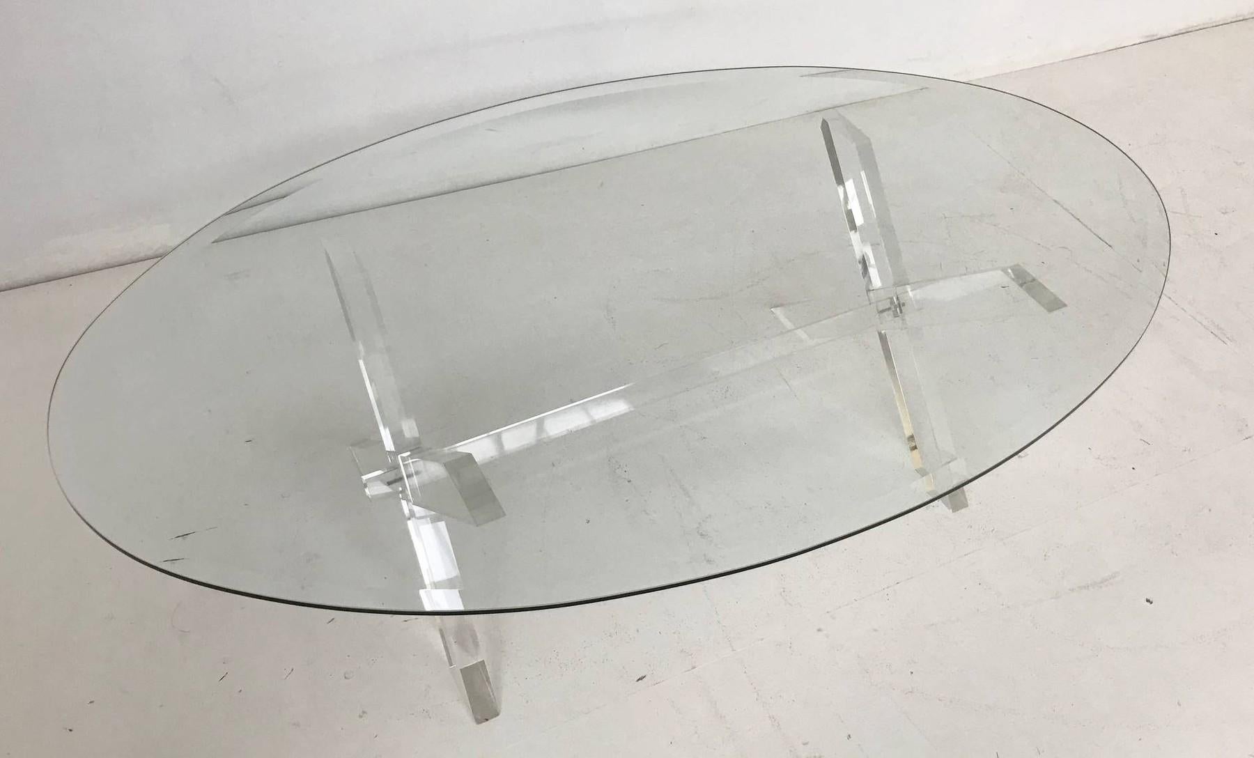 X leg acrylic and oval glass coffee table.