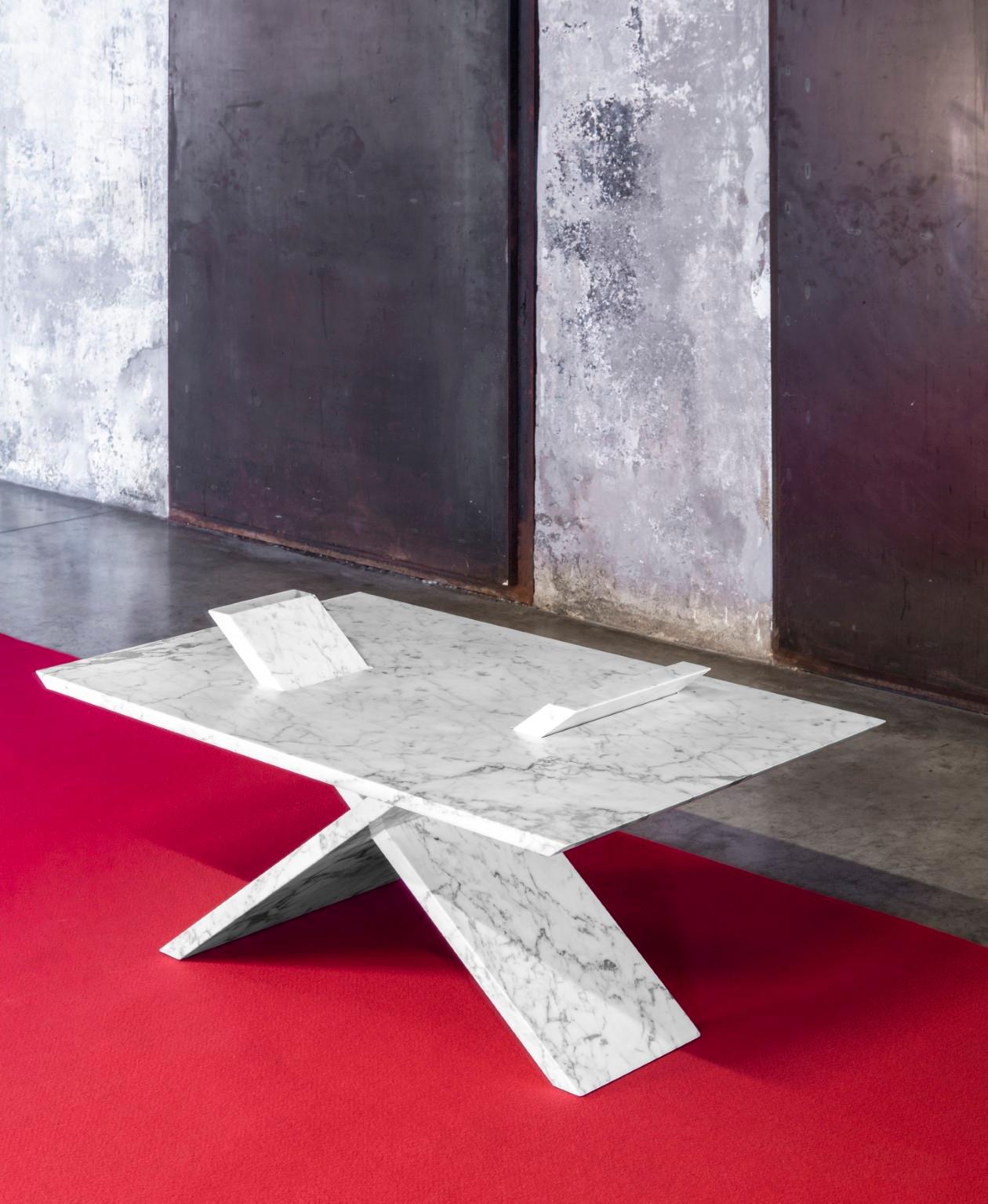 X-Marble by Mentemano
Dimensions: W 95 x D 60 x H 47 cm
Materials: Marmo di Carrara

This coffee table presents an X shape base partly coming out from the surface. The marble elements form an intersection of slabs, making a focus on the unique