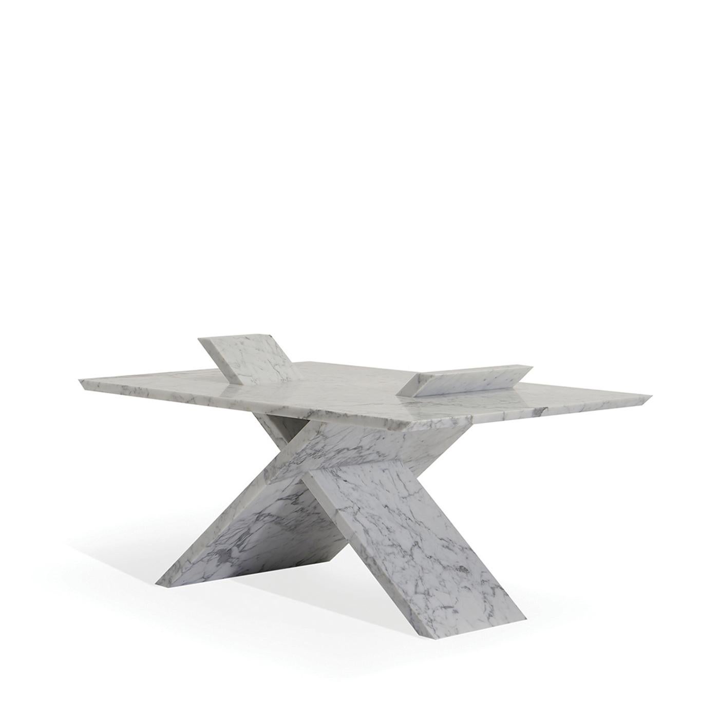 Three pieces of marble are pieces together in a unique way to create an all-new conception of a dining table. In fine Carrara marble, the table sits on an X shaped base that comes through the table's surface to dialogue with your meals. The table is