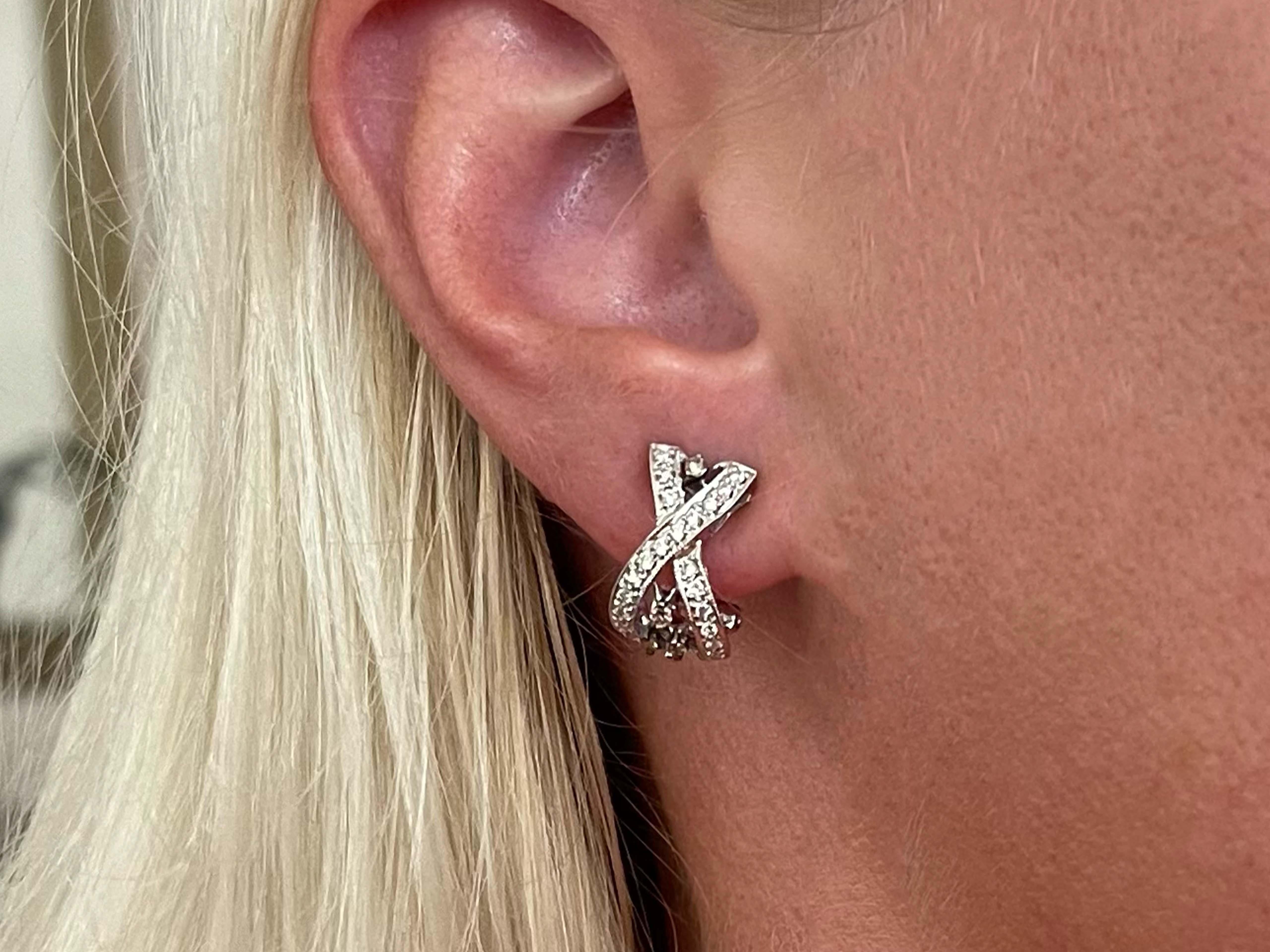 Earrings Specifications:

Metal: 18k White Gold

Total Weight: 5.3 Grams

Earring Measurements: 15.7 mm x 9 mm

Diamonds: 42 White Round Brilliant Cut Diamonds and 8 chocolate diamonds
Color: H-I

Clarity: SI1-SI2

Total Diamond Carat Weight: ~ .20