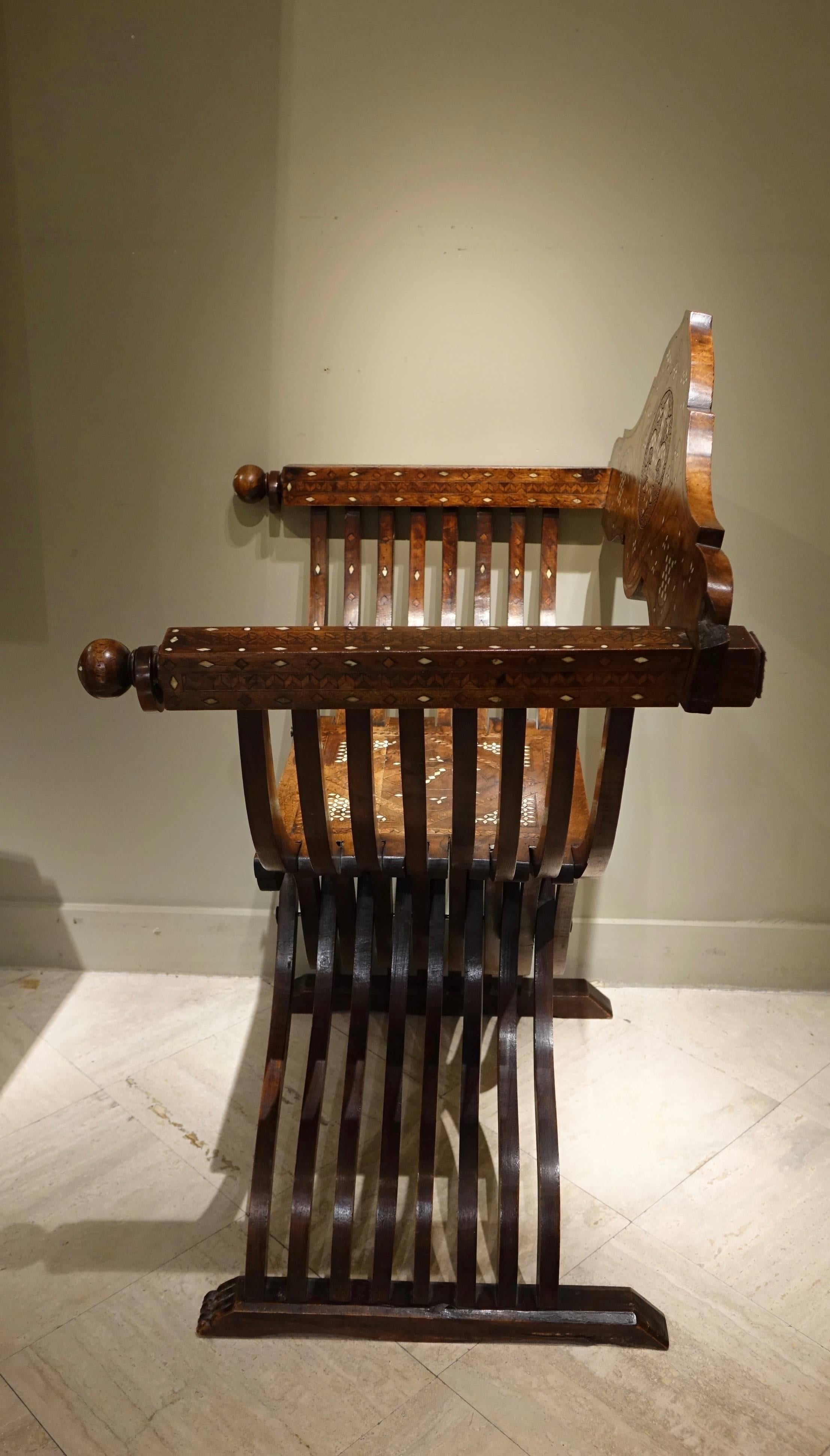X-shaped stool with back and armrests in Renaissance style in walnut with bone inlaid,
Italy, 19th century.