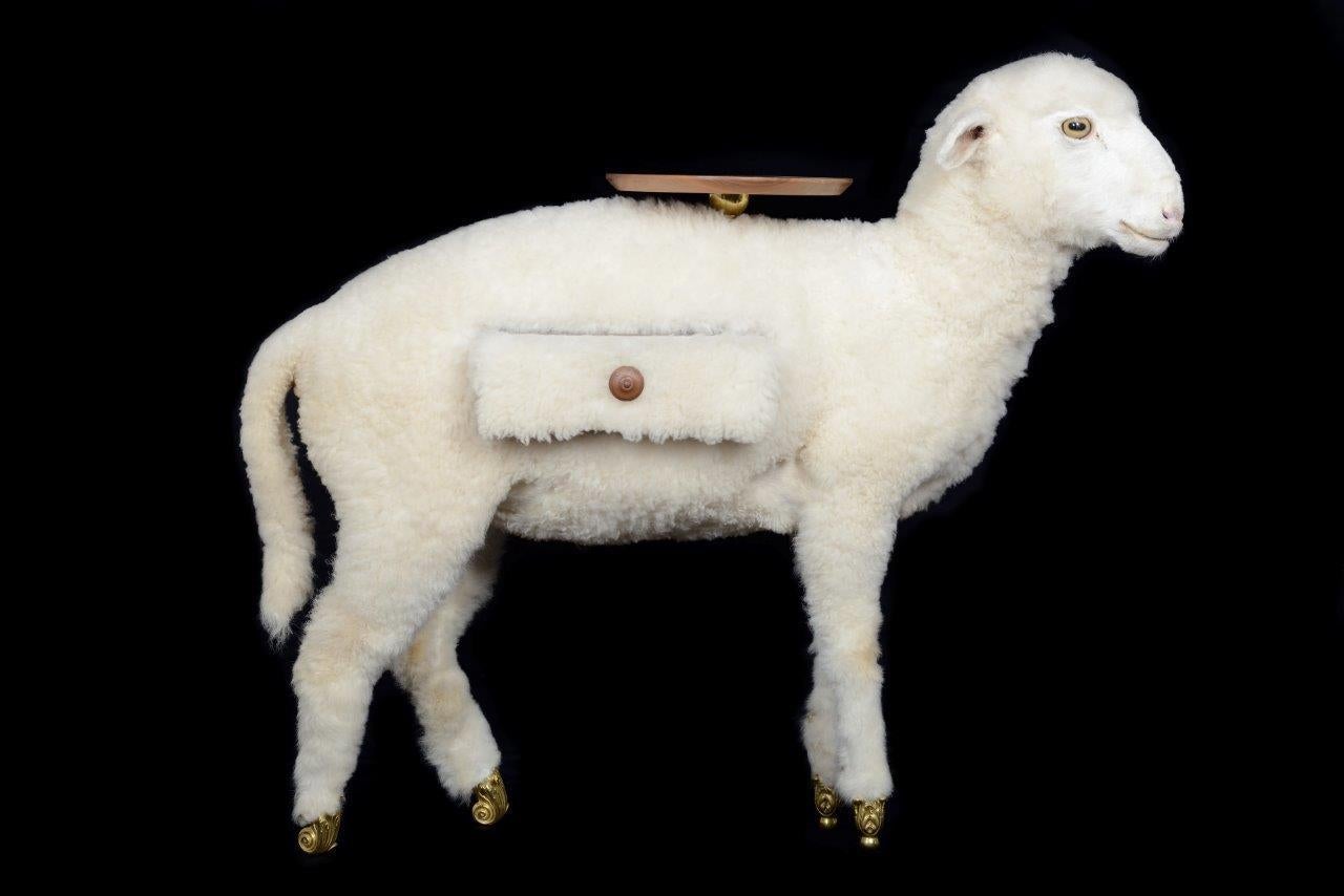Design inspired on an artwork by Salvador Dali´: Interpretation project for a stable-library, 1942
Stuffed lamb, elaborated with a technique by a taxidermist. Drawer and table top in solid varnished walnut wood. Hooves in gilt solid bronze.

This