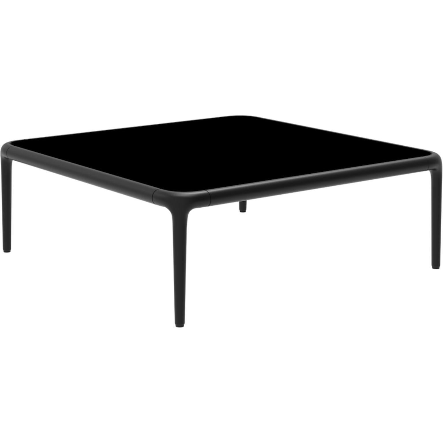 Xaloc black coffee table 80 with glass top by Mowee.
Dimensions: D80 x W80 x H28 cm.
Materials: Aluminum, tinted tempered glass top.
Also available in different aluminum colors and finishes (HPL Black Edge or Neolith). 

Xaloc synthesizes the