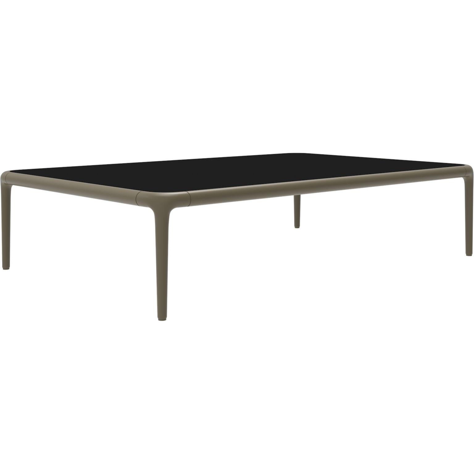 Xaloc Bronze coffee table 120 with glass top by MOWEE
Dimensions: D120 x W80 x H28 cm
Materials: Aluminum, tinted tempered glass top.
Also available in different aluminum colors and finishes (HPL Black Edge or Neolith). 

Xaloc synthesizes the