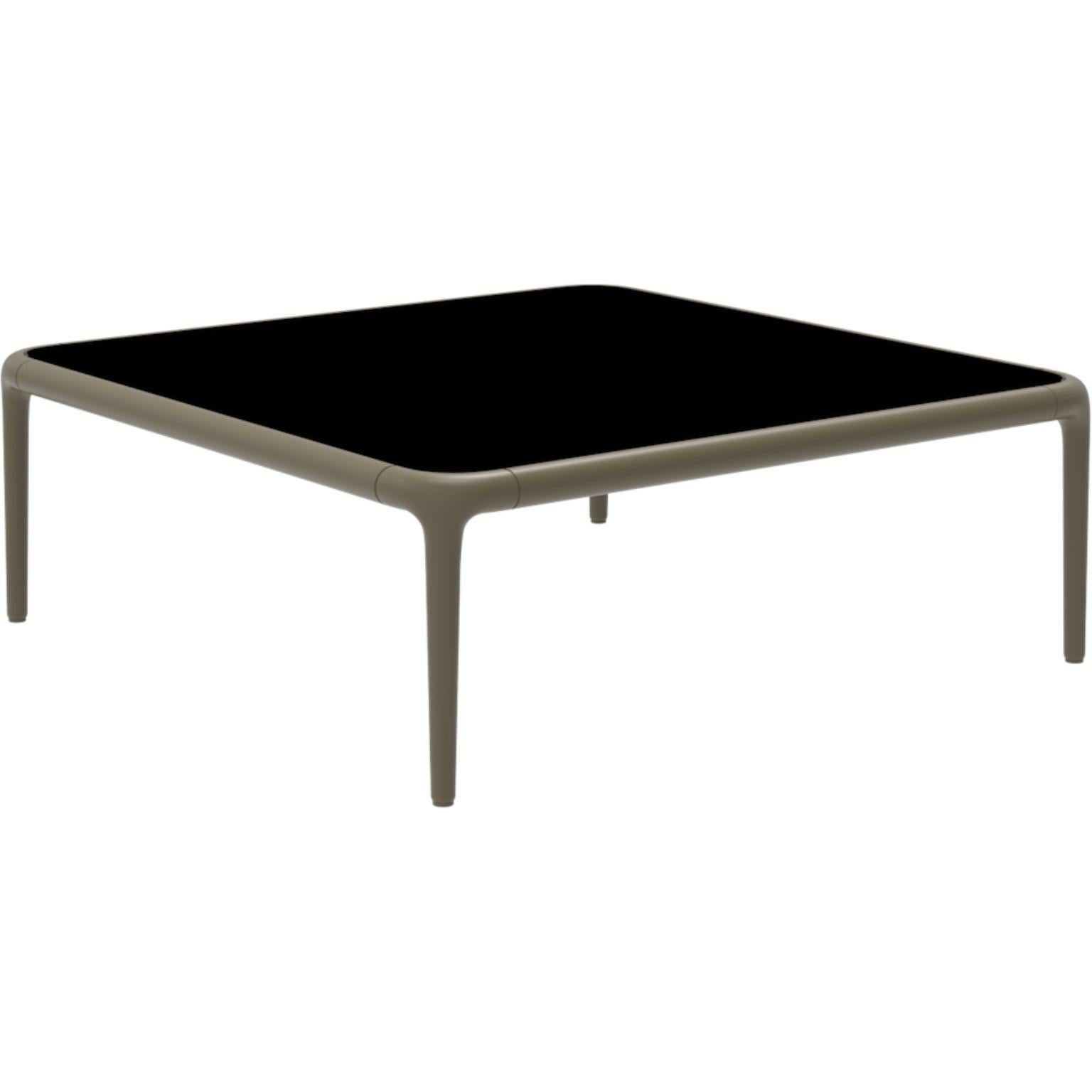 Xaloc Bronze coffee table 80 with glass top by Mowee.
Dimensions: D80 x W80 x H28 cm.
Materials: Aluminum, tinted tempered glass top.
Also available in different aluminum colors and finishes (HPL Black Edge or Neolith). 

Xaloc synthesizes the