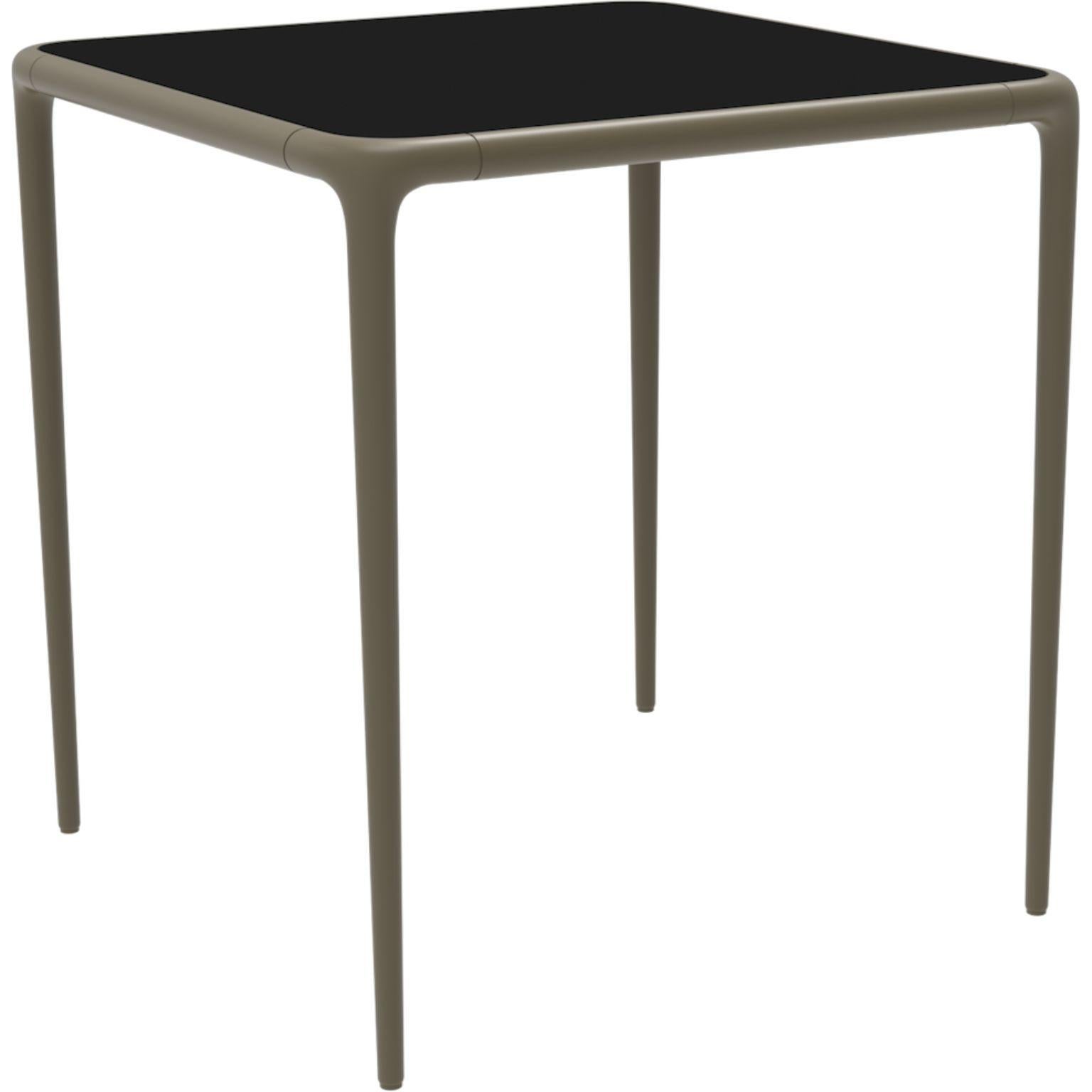 Xaloc bronze glass top table 70 by Mowee.
Dimensions: D70 x W70 x H74 cm.
Material: Aluminum, tinted tempered glass top.
Also available in different aluminum colors and finishes (HPL Black Edge or Neolith).

Xaloc synthesizes the lines of