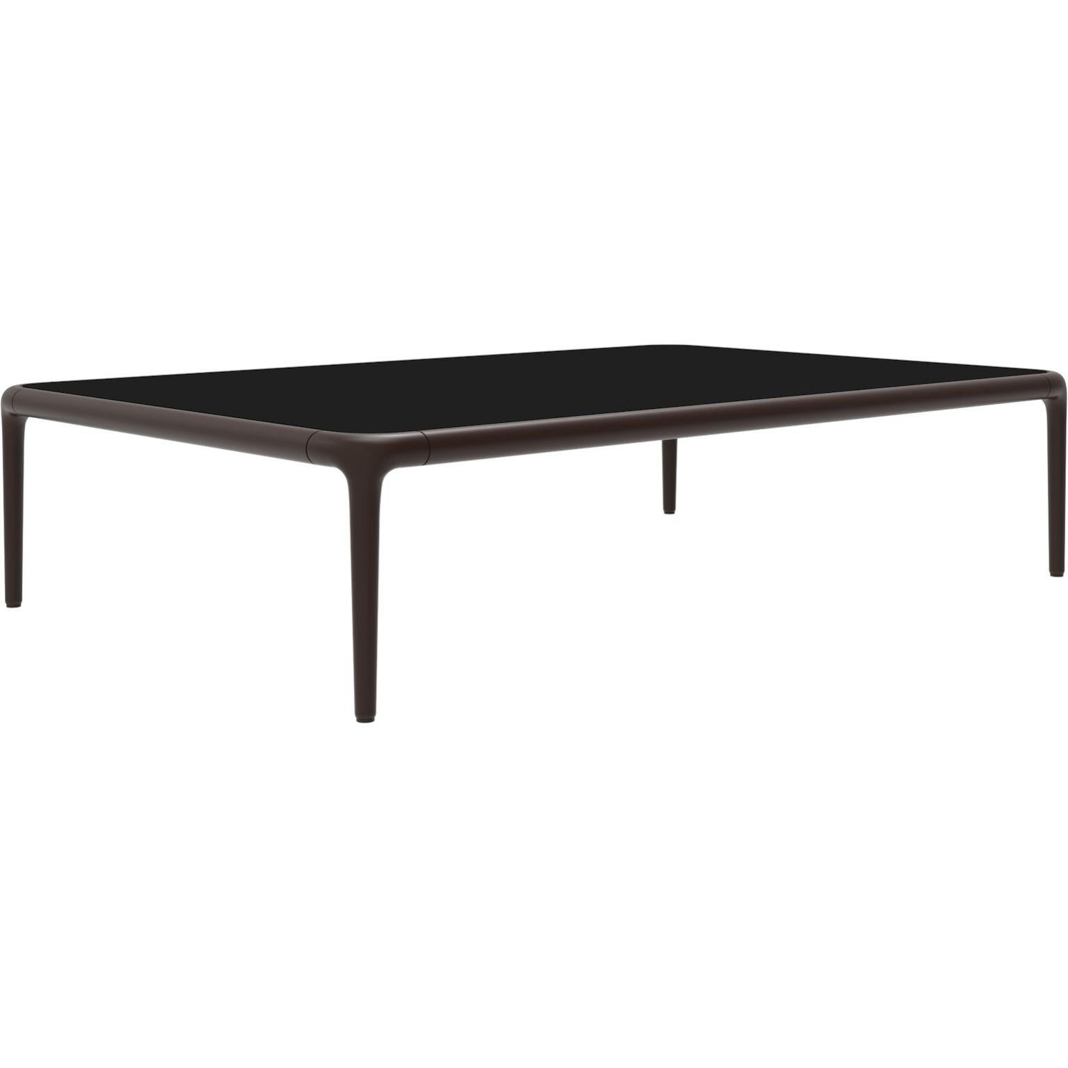 Xaloc chocolate coffee table 120 with glass top by MOWEE
Dimensions: D120 x W80 x H28 cm
Materials: Aluminum, tinted tempered glass top.
Also available in different aluminum colors and finishes (HPL Black Edge or Neolith). 

Xaloc synthesizes