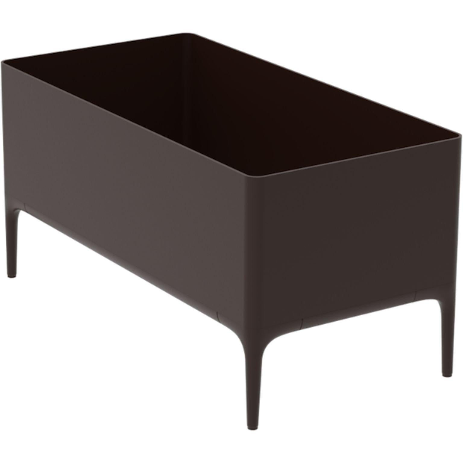 Xaloc Chocolate Planter by MOWEE
Dimensions: D90 x W45 x H45 cm
Material: Aluminium
Weight: 11 kg
Also Available in different colours and finishes. 

 Xaloc synthesizes the lines of interior furniture to extrapolate to the exterior, creating