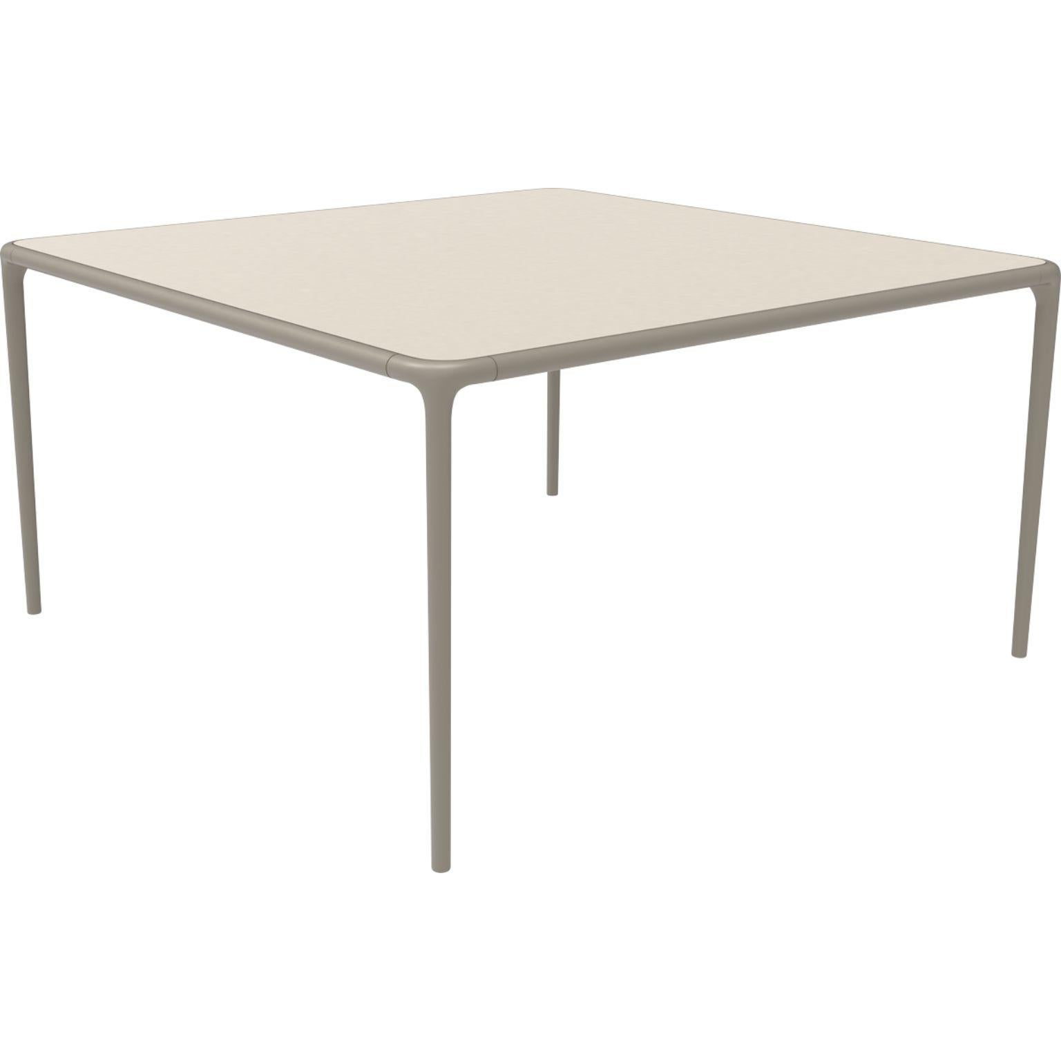 Xaloc cream glass top table 140 by Mowee
Dimensions: D 140 x W 140 x H 74 cm
Material: Aluminum, tinted tempered glass top.
Also available in different aluminum colors and finishes (HPL Black Edge or Neolith).

 Xaloc synthesizes the lines of