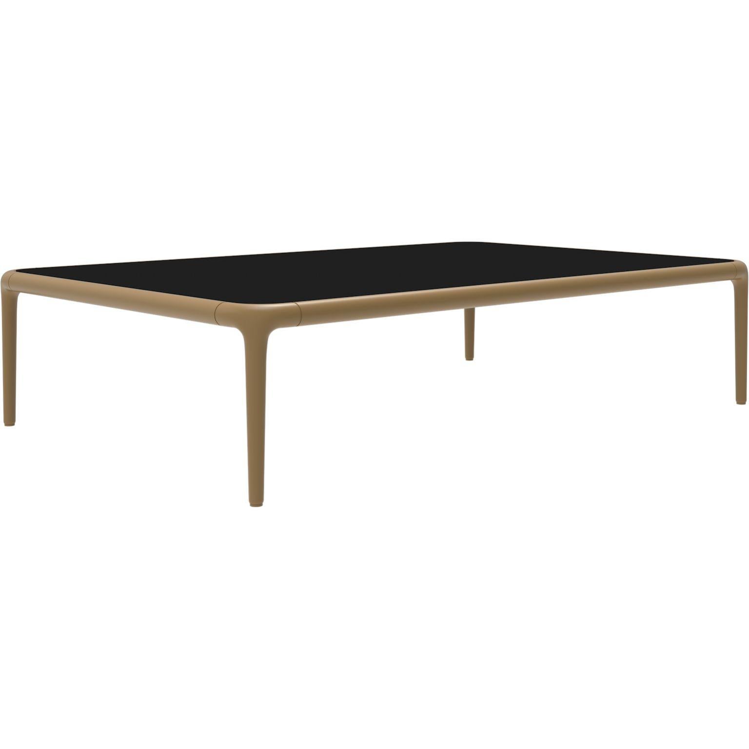 Xaloc gold coffee table 120 with glass top by MOWEE
Dimensions: D120 x W80 x H28 cm
Materials: Aluminum, tinted tempered glass top.
Also available in different aluminum colors and finishes (HPL Black Edge or Neolith).

Xaloc synthesizes the