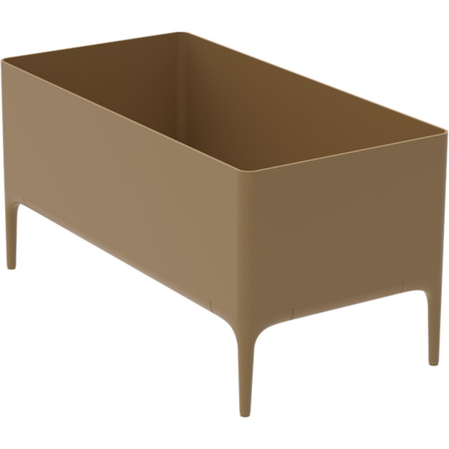 Xaloc Gold Planter by MOWEE
Dimensions: D90 x W45 x H45 cm
Material: Aluminium
Weight: 11 kg
Also Available in different colours and finishes. 

 Xaloc synthesizes the lines of interior furniture to extrapolate to the exterior, creating an