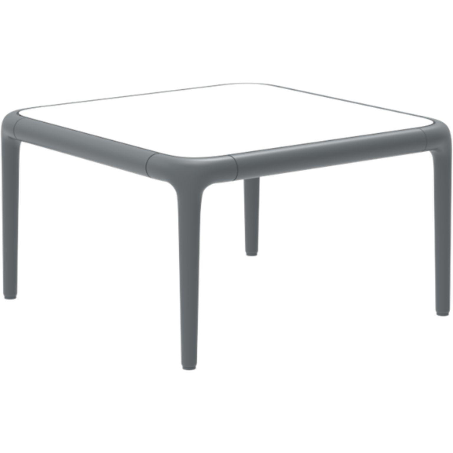 Xaloc grey coffee table 50 with glass top by Mowee.
Dimensions: D50 x W50 x H28 cm
Materials: Aluminum, tinted tempered glass top.
Also available in different aluminum colors and finishes (HPL Black Edge or Neolith).

Xaloc synthesizes the