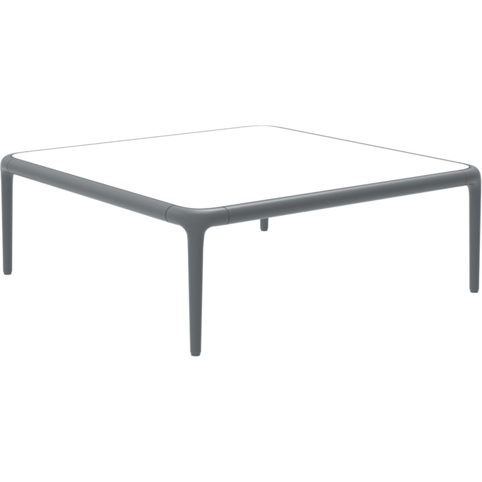 Xaloc grey coffee table 80 with glass top by Mowee.
Dimensions: D80 x W80 x H28 cm
Materials: Aluminum, tinted tempered glass top.
Also available in different aluminum colors and finishes (HPL Black Edge or Neolith). 

Xaloc synthesizes the
