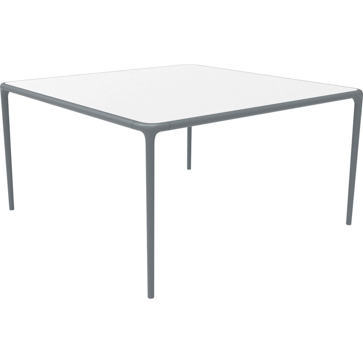 Xaloc grey glass top table 140 by MOWEE
Dimensions: D140 x W140 x H74 cm
Material: Aluminum, tinted tempered glass top.
Also available in different aluminum colors and finishes (HPL Black Edge or Neolith). 

 Xaloc synthesizes the lines of