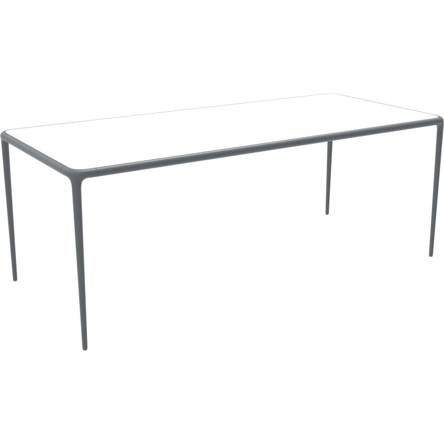 Xaloc grey glass top 200 table by Mowee
Dimensions: D 200 x W 90 x H 74 cm
Material: Aluminum, tinted tempered glass top.
Also available in different aluminum colors and finishes (HPL Black Edge or Neolith).

Xaloc synthesizes the lines of