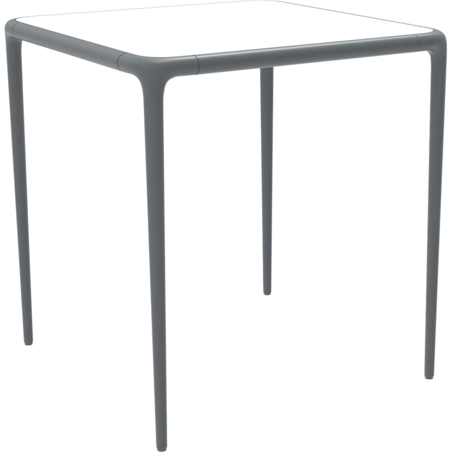 Xaloc grey glass top table 70 by MOWEE
Dimensions: D70 x W70 x H74 cm
Material: Aluminum, tinted tempered glass top.
Also available in different aluminum colors and finishes (HPL Black Edge or Neolith).

Xaloc synthesizes the lines of interior