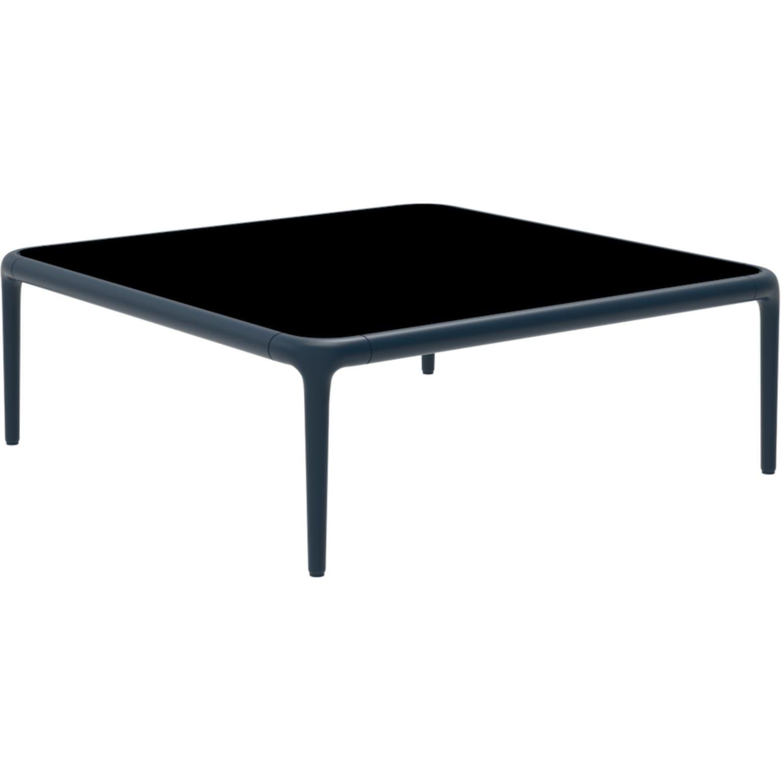 Xaloc Navy coffee table 80 with Glass top by Mowee
Dimensions: D80 x W80 x H28 cm
Materials: Aluminum, tinted tempered glass top.
Also available in different aluminum colors and finishes (HPL Black Edge or Neolith).

Xaloc synthesizes the lines