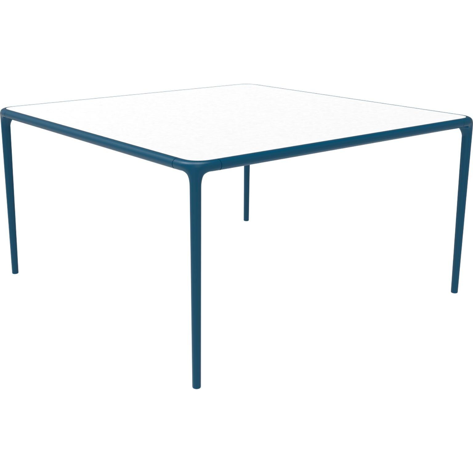 Xaloc navy glass top table 140 by MOWEE
Dimensions: D140 x W140 x H74 cm
Material: Aluminum, tinted tempered glass top.
Also available in different aluminum colors and finishes (HPL Black Edge or Neolith). 

Xaloc synthesizes the lines of
