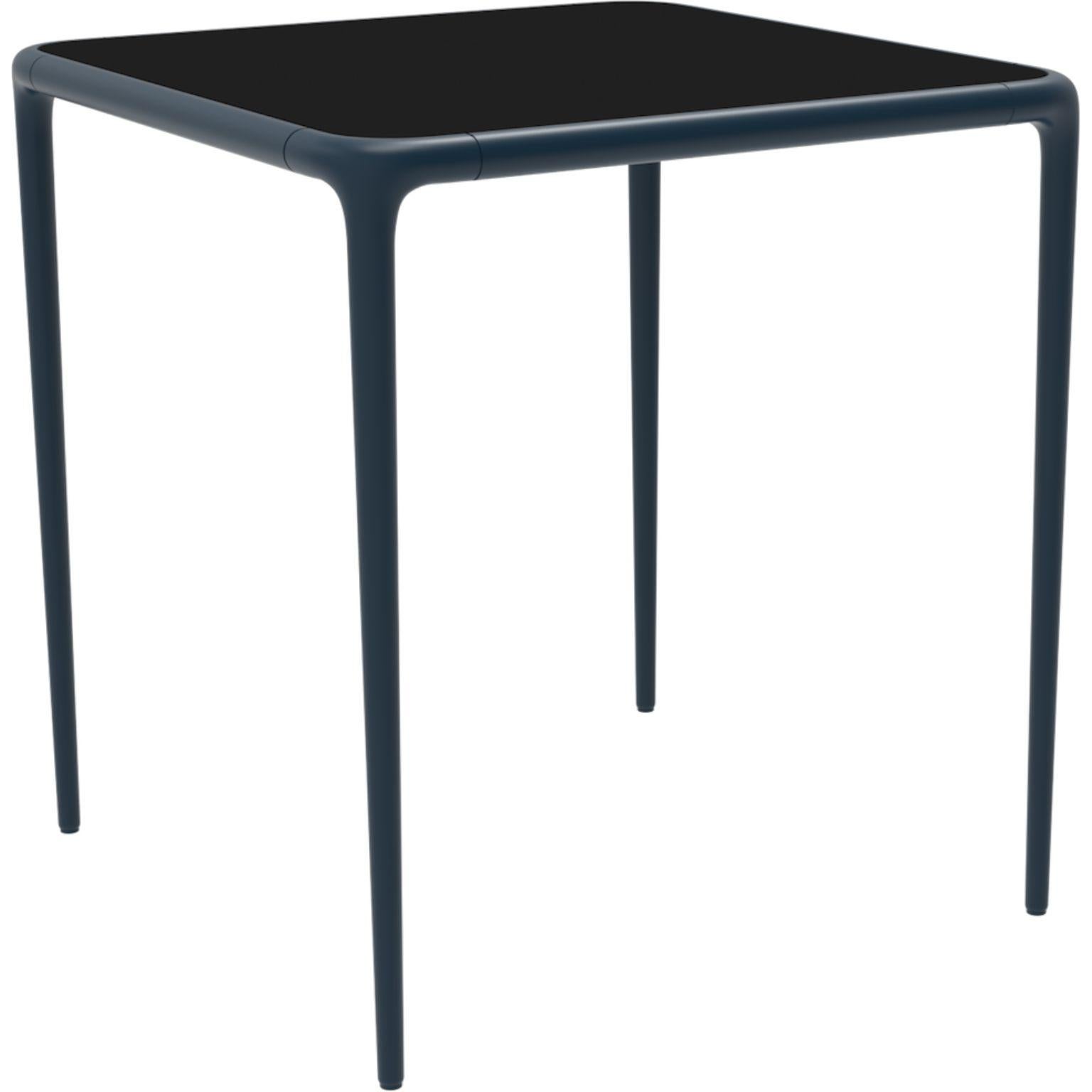 Xaloc Navy glass top table 70 by Mowee
Dimensions: D 70 x W 70 x H 74 cm
Material: Aluminum, tinted tempered glass top.
Also available in different aluminum colors and finishes (HPL Black Edge or Neolith).

Xaloc synthesizes the lines of