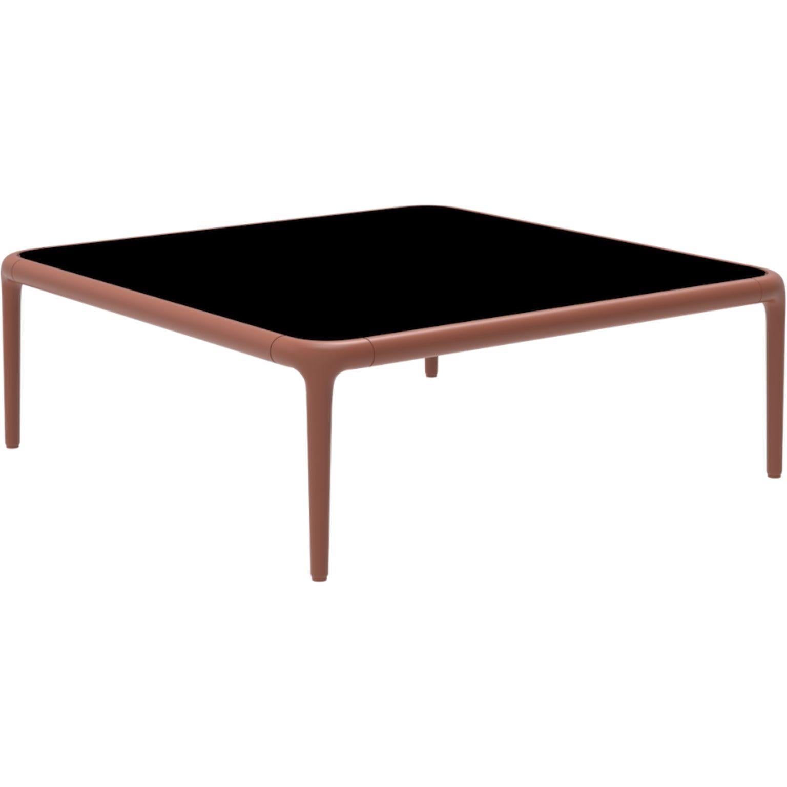 Xaloc salmon coffee table 80 with Glass top by Mowee.
Dimensions: D80 x W80 x H28 cm.
Materials: Aluminum, tinted tempered glass top.
Also available in different aluminum colors and finishes (HPL Black Edge or Neolith). 

Xaloc synthesizes the